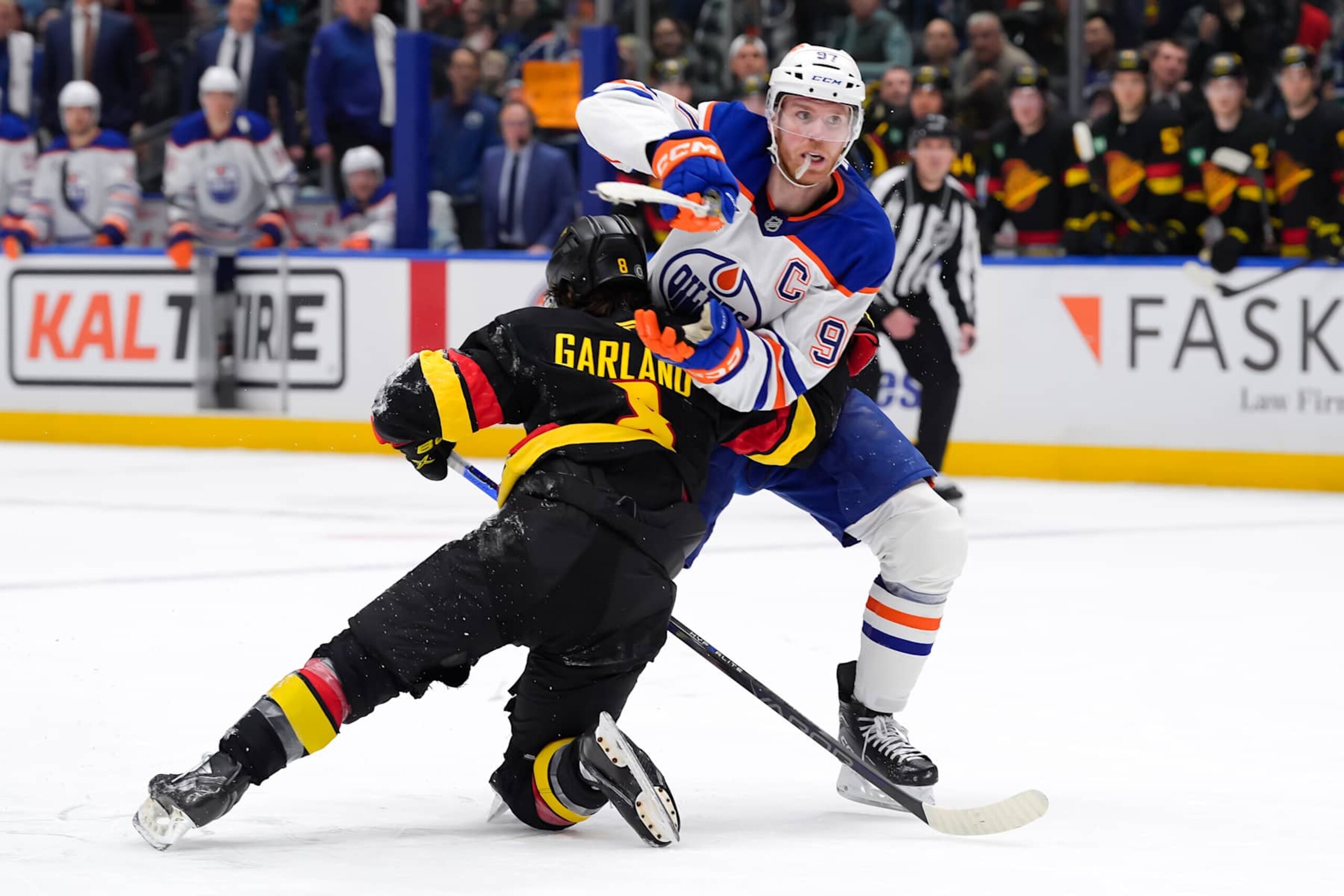 VANCOUVER, CANADA - JANUARY 18: Connor McDavid #97 of the Edmonton Oilers is checked by Conor Garland #8 of the Vancouver Canucks during the third period of their NHL game at Rogers Arena on January 18, 2025 in Vancouver, British Columbia, Canada. (Photo by Derek Cain/Getty Images) VANCOUVER, CANADA - JANUARY 18: Connor McDavid #97 of the Edmonton Oilers is checked by Conor Garland #8 of the Vancouver Canucks during the third period of their NHL game at Rogers Arena on January 18, 2025 in Vancouver, British Columbia, Canada. (Photo by Derek Cain/Getty Images)
