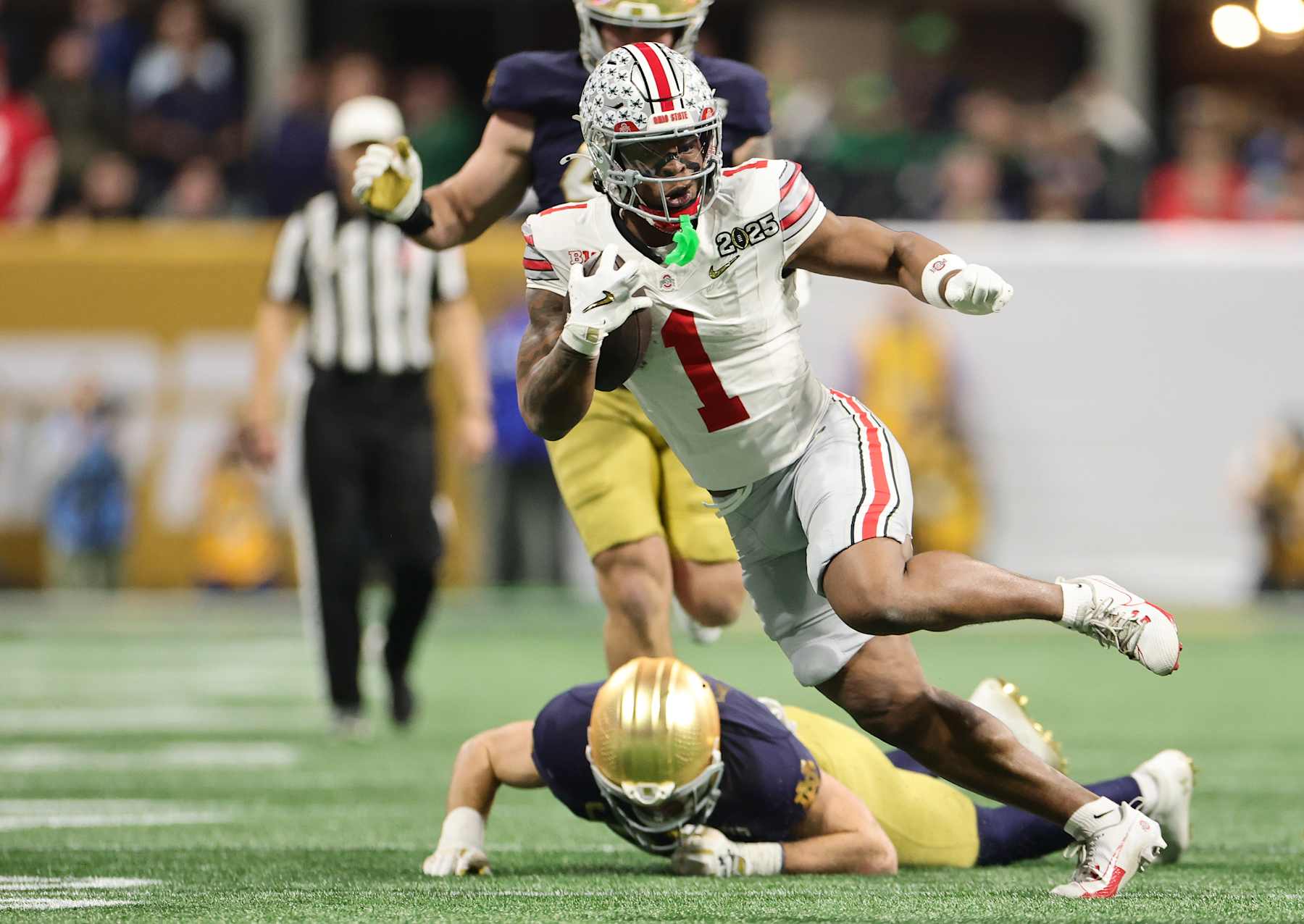 ATLANTA, GEORGIA - JANUARY 20: Quinshon Judkins #1 of the Ohio State Buckeyes runs with the ball against the Notre Dame Fighting Irish in the first quarter during the 2025 CFP National Championship at the Mercedes-Benz Stadium on January 20, 2025 in Atlanta, Georgia. (Photo by Carmen Mandato/Getty Images)