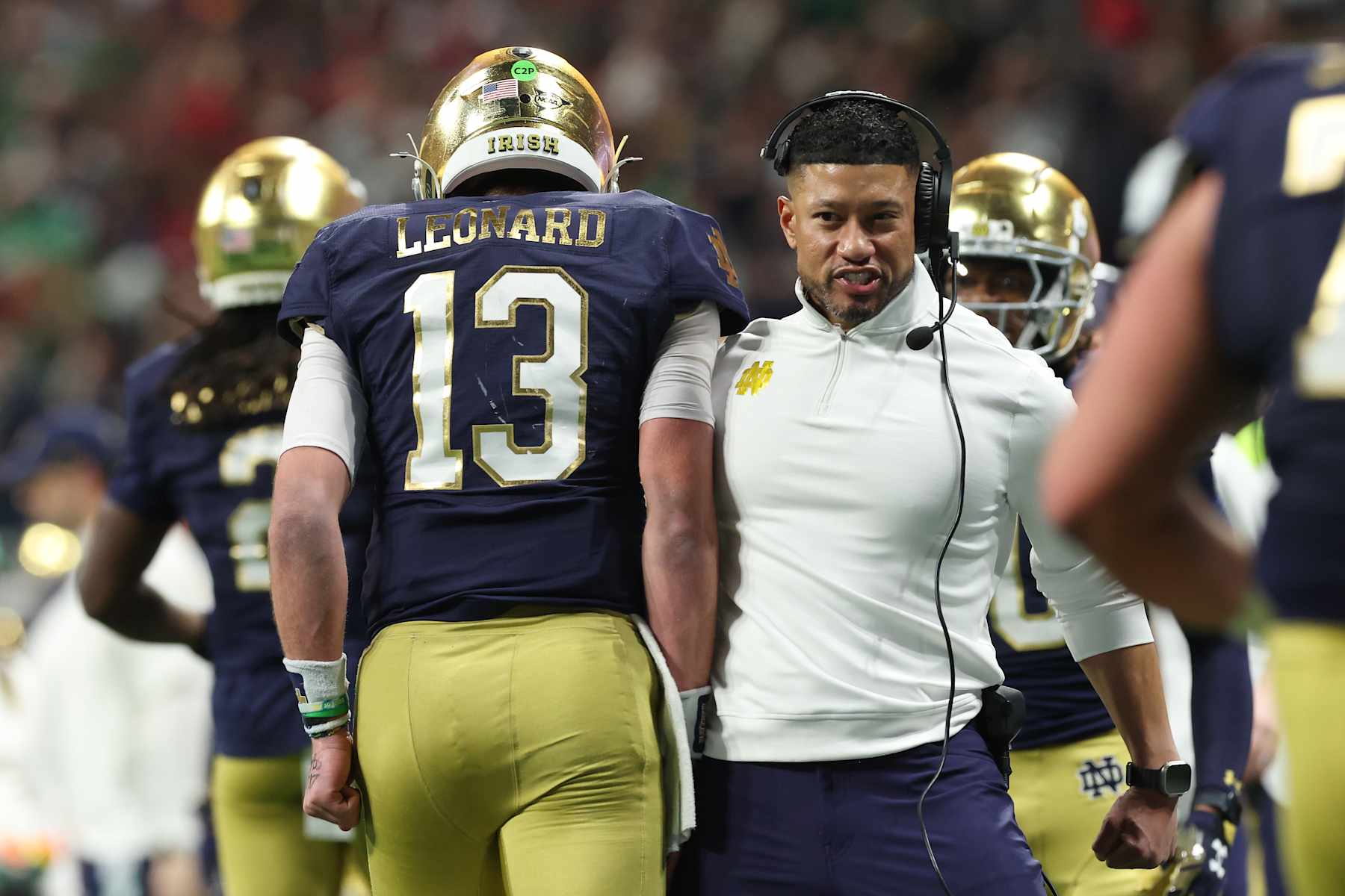 ATLANTA, GEORGIA - JANUARY 20: Riley Leonard #13 and head coach Marcus Freeman of the Notre Dame Fighting Irish celebrate after a first quarter touchdown against the Ohio State Buckeyes during the 2025 CFP National Championship at the Mercedes-Benz Stadium on January 20, 2025 in Atlanta, Georgia. (Photo by Jamie Squire/Getty Images)
