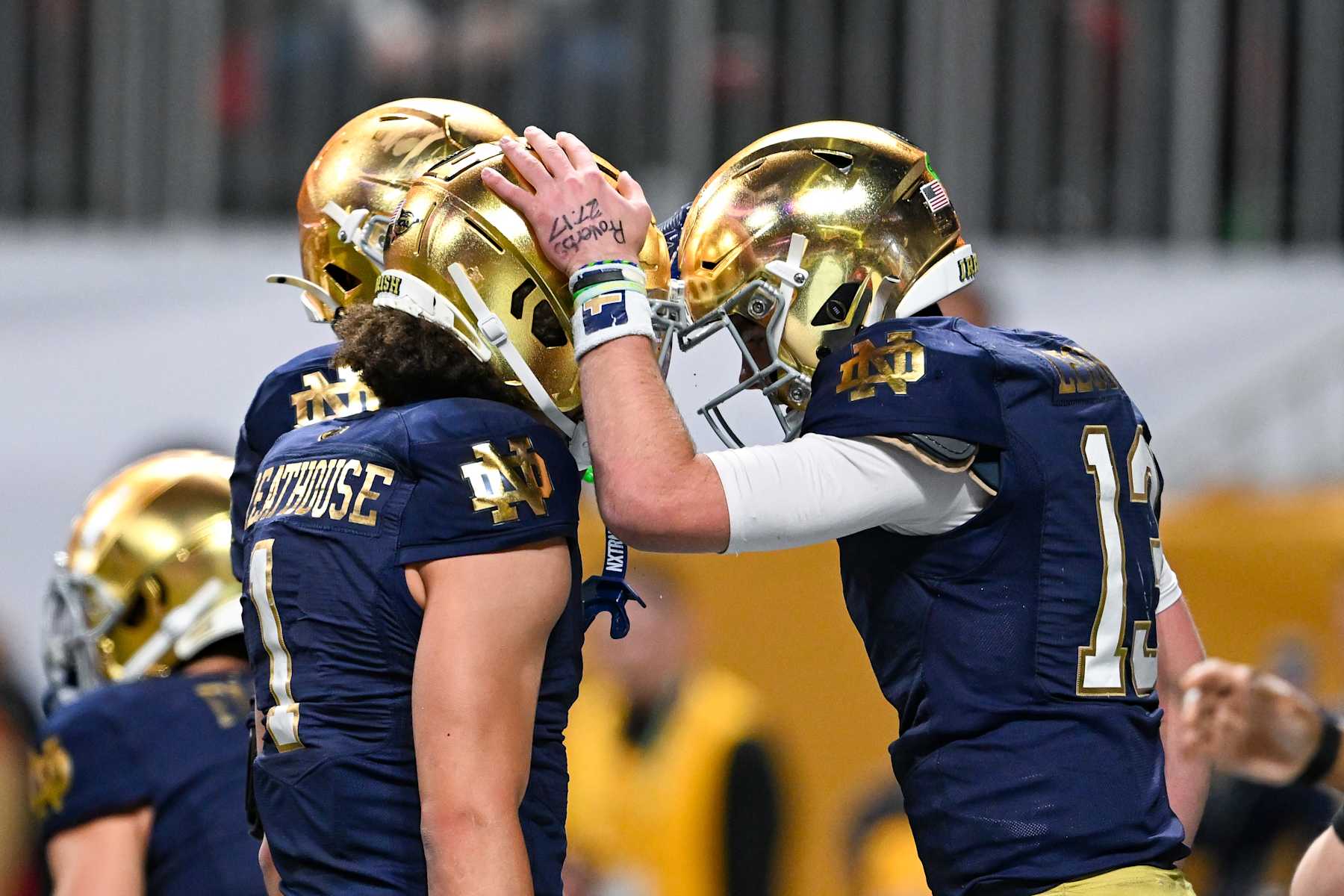 ATLANTA, GA  JANUARY 20:  Quarterback Riley Leonard #13 and Wide Receiver Jaden Greathouse #1 of the Notre Dame Fighting Irish react after Leonard's touchdown during the Ohio State Buckeyes versus Notre Dame Fighting Irish College Football Playoff National Championship game on January 20, 2025, at Mercedes-Benz Stadium in Atlanta, GA.  (Photo by Rich von Biberstein/Icon Sportswire via Getty Images)