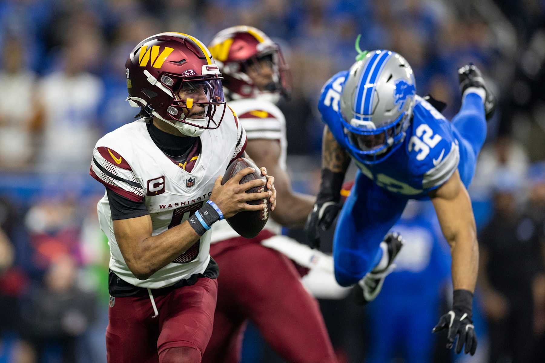 DETROIT, MICHIGAN - JANUARY 18: Jayden Daniels #5 of the Washington Commanders scrambles and looks to pass during an NFL Football game against the Detroit Lions at Ford Field on January 18, 2025 in Detroit, Michigan. (Photo by Michael Owens/Getty Images)