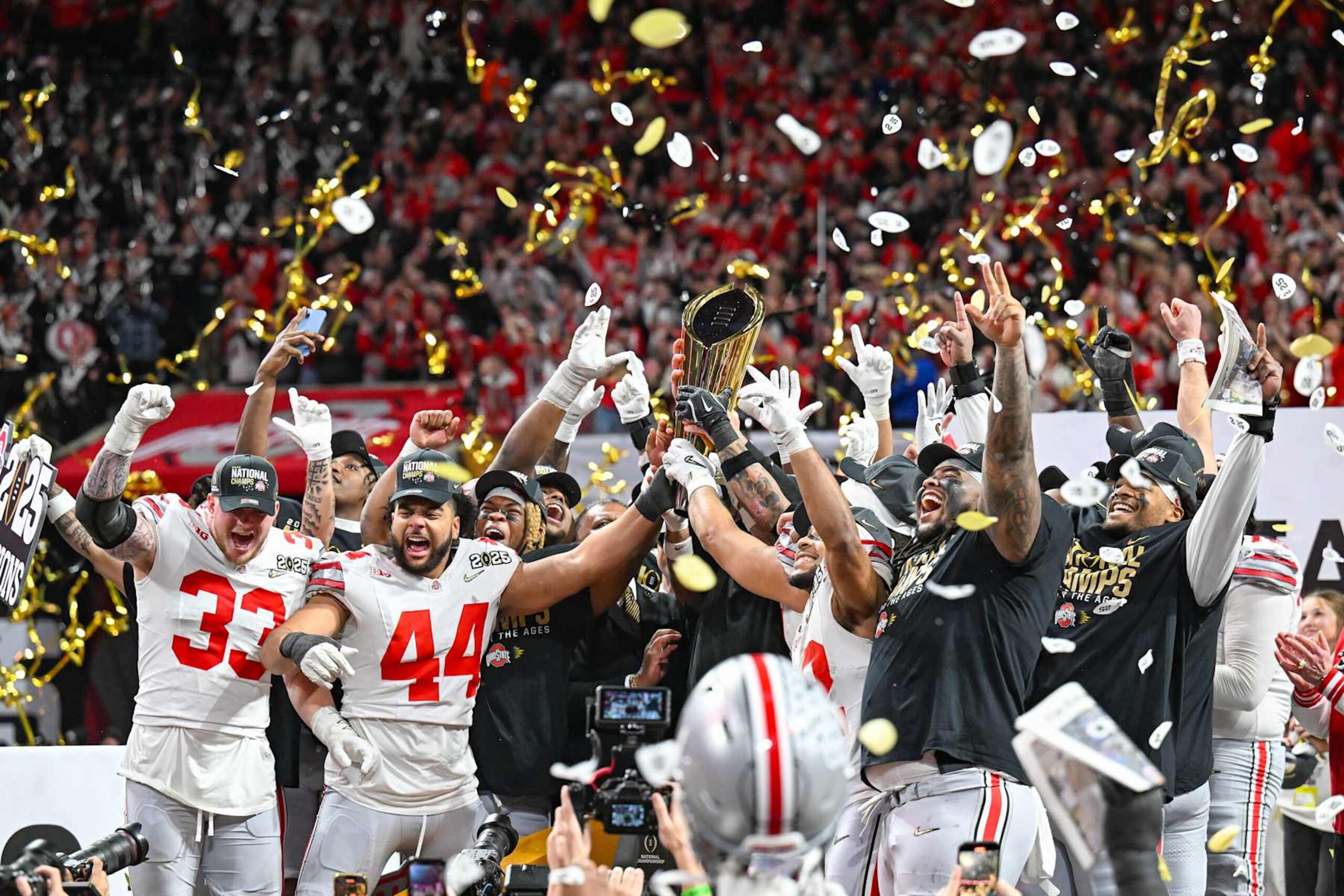ATLANTA, GA JANUARY 20: Ohio State players celebrate with the winning trophy following the conclusion of the the Ohio State Buckeyes versus Notre Dame Fighting Irish College Football Playoff National Championship game on January 20, 2025, at Mercedes-Benz Stadium in Atlanta, GA. (Photo by Rich von Biberstein/Icon Sportswire via Getty Images) ATLANTA, GA JANUARY 20: Ohio State players celebrate with the winning trophy following the conclusion of the the Ohio State Buckeyes versus Notre Dame Fighting Irish College Football Playoff National Championship game on January 20, 2025, at Mercedes-Benz Stadium in Atlanta, GA. (Photo by Rich von Biberstein/Icon Sportswire via Getty Images)