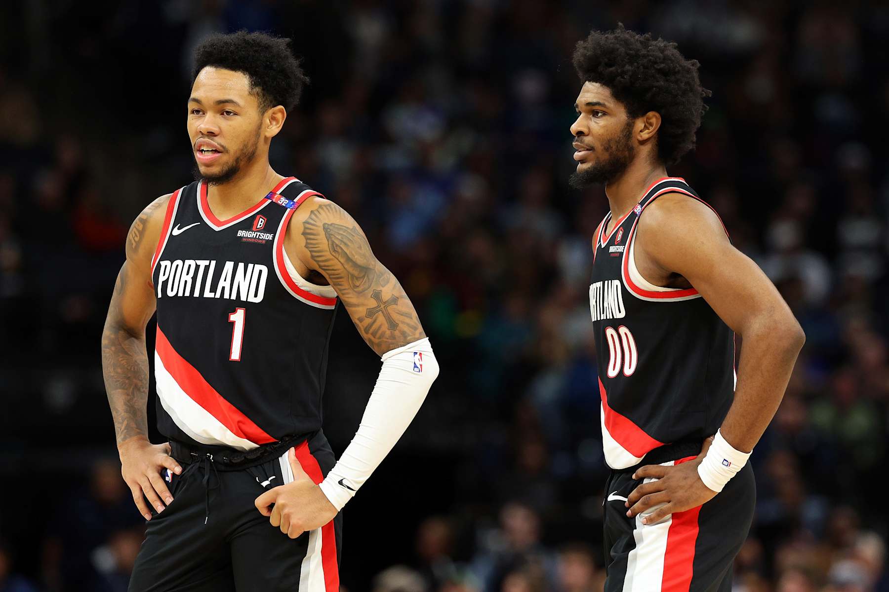 MINNEAPOLIS, MINNESOTA - NOVEMBER 08: Anfernee Simons #1 (L) and Scoot Henderson #00 of the Portland Trail Blazers look on against the Minnesota Timberwolves in the second quarter at Target Center on November 08, 2024 in Minneapolis, Minnesota. NOTE TO USER: User expressly acknowledges and agrees that, by downloading and or using this photograph, User is consenting to the terms and conditions of the Getty Images License Agreement. (Photo by David Berding/Getty Images)