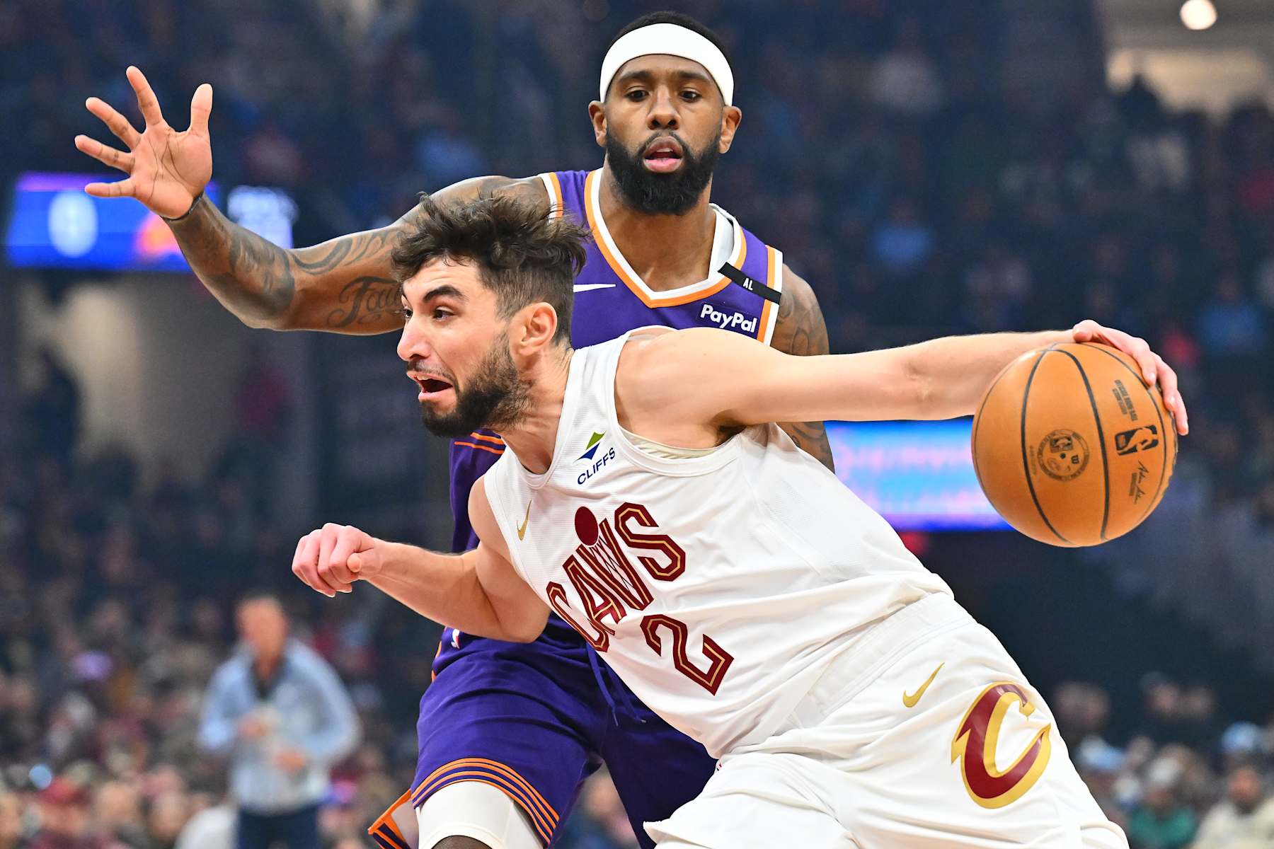CLEVELAND, OHIO - JANUARY 20: Royce O'Neale #00 of the Phoenix Suns guards Ty Jerome #2 of the Cleveland Cavaliers during the first quarter at Rocket Mortgage Fieldhouse on January 20, 2025 in Cleveland, Ohio. NOTE TO USER: User expressly acknowledges and agrees that, by downloading and or using this photograph, User is consenting to the terms and conditions of the Getty Images License Agreement. (Photo by Jason Miller/Getty Images)