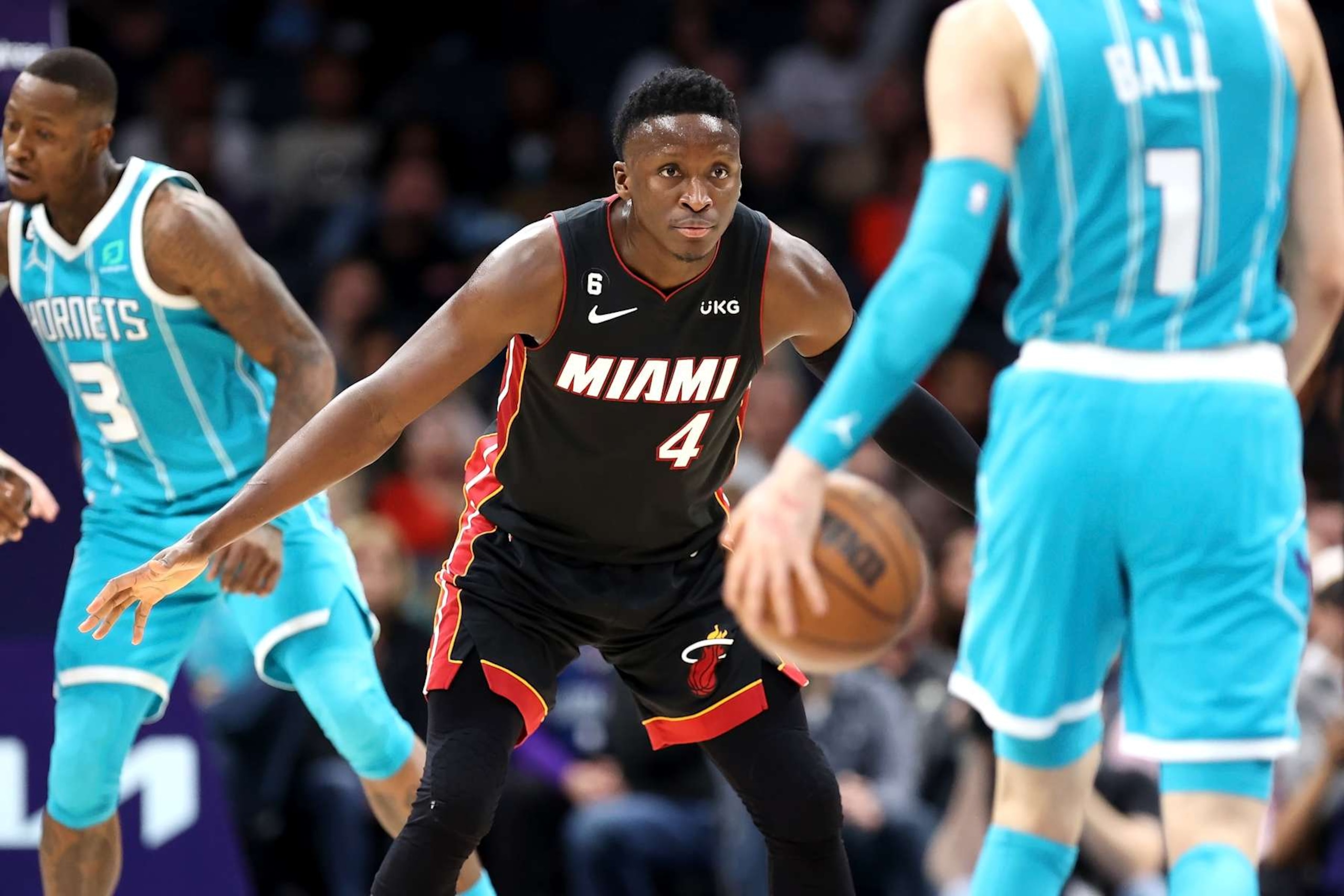 CHARLOTTE, NORTH CAROLINA - JANUARY 29: Victor Oladipo #4 of the Miami Heat defends LaMelo Ball #1 of the Charlotte Hornets as he brings the ball down the court during the fourth quarter of a basketball game at Spectrum Center on January 29, 2023 in Charlotte, North Carolina. NOTE TO USER: User expressly acknowledges and agrees that, by downloading and or using this photograph, User is consenting to the terms and conditions of the Getty Images License Agreement. (Photo by David Jensen/Getty Images)