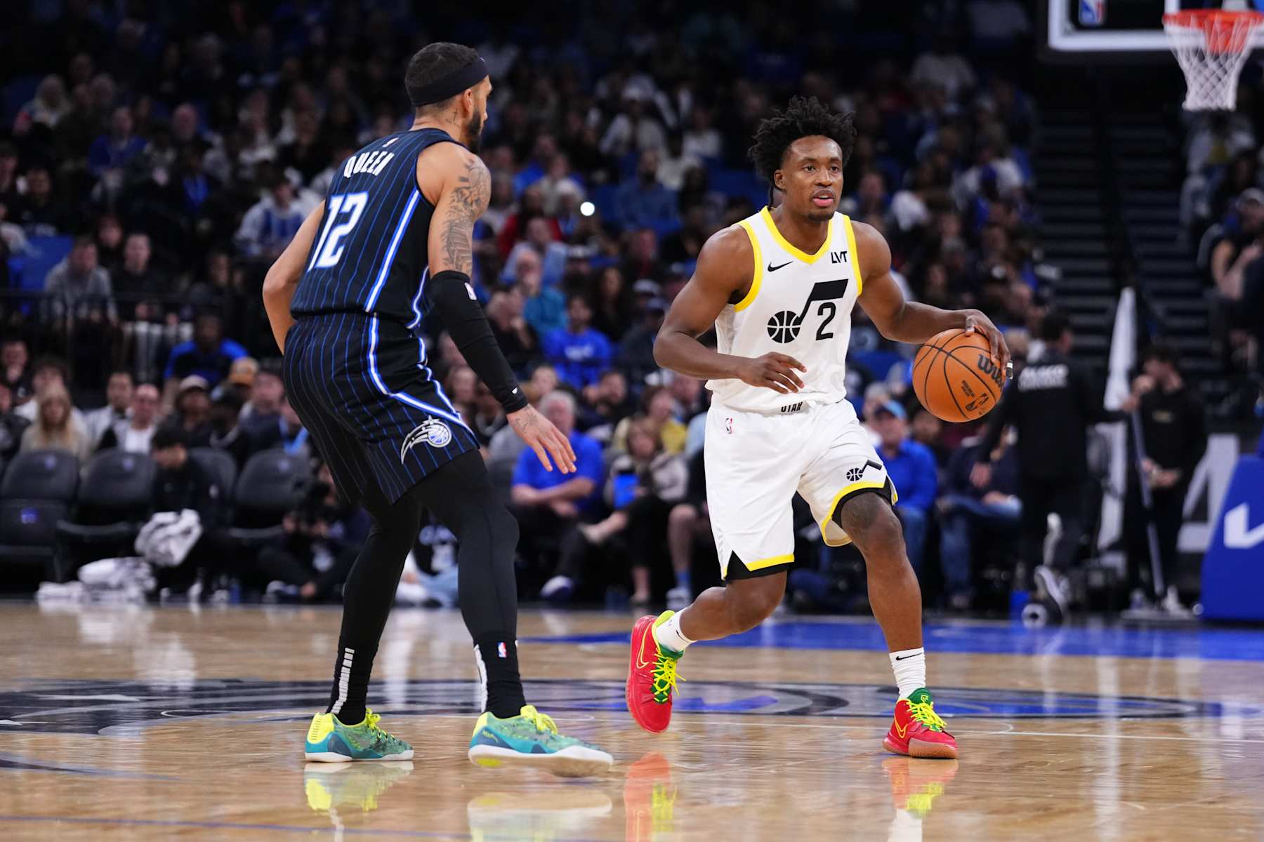 ORLANDO, FLORIDA - JANUARY 05: Collin Sexton #2 of the Utah Jazz dribbles the ball against Trevelin Queen #12 of the Orlando Magic during the third quarter at Kia Center on January 05, 2025 in Orlando, Florida. NOTE TO USER: User expressly acknowledges and agrees that, by downloading and or using this photograph, User is consenting to the terms and conditions of the Getty Images License Agreement. (Photo by Rich Storry/Getty Images)
