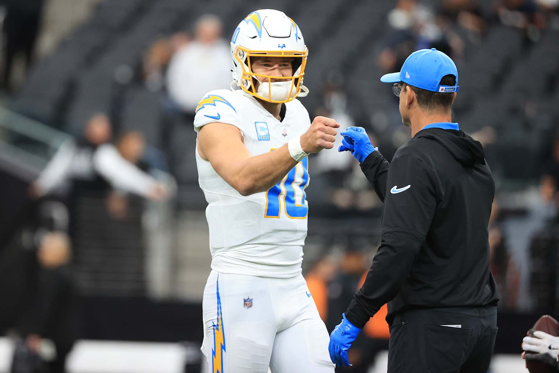 LAS VEGAS, NEVADA - JANUARY 05: Justin Herbert #10 and head coach Jim Harbaugh of the Los Angeles Chargers fist bump prior to the game against the Las Vegas Raiders at Allegiant Stadium on January 05, 2025 in Las Vegas, Nevada. (Photo by Ian Maule/Getty Images)