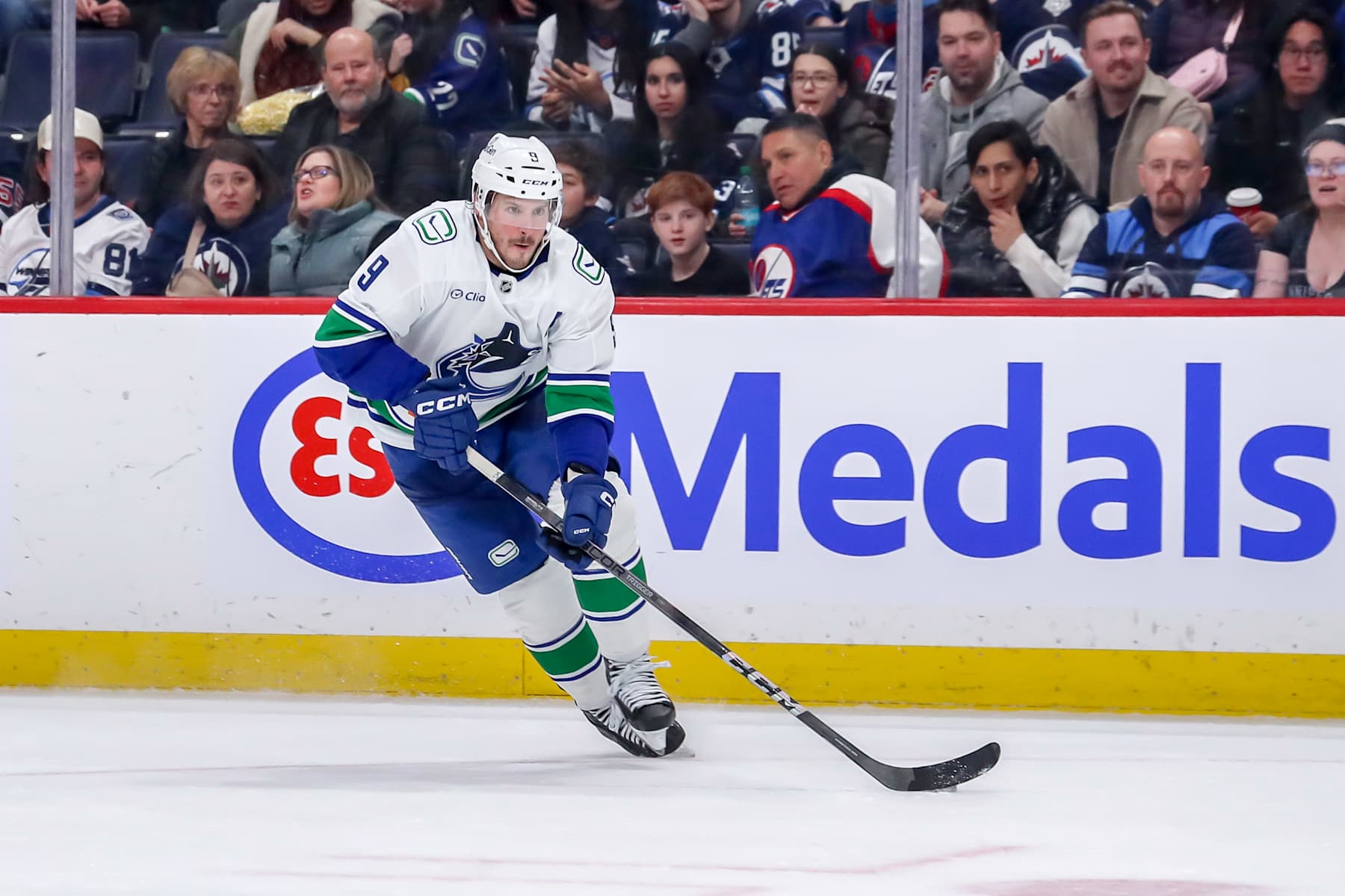 WINNIPEG, CANADA - JANUARY 14: J.T. Miller #9 of the Vancouver Canucks carries the puck down the ice during third period action against the Winnipeg Jets at the Canada Life Centre on January 14, 2025 in Winnipeg, Manitoba, Canada. The Jets defeated the Canucks 6-1. (Photo by Darcy Finley/NHLI via Getty Images)