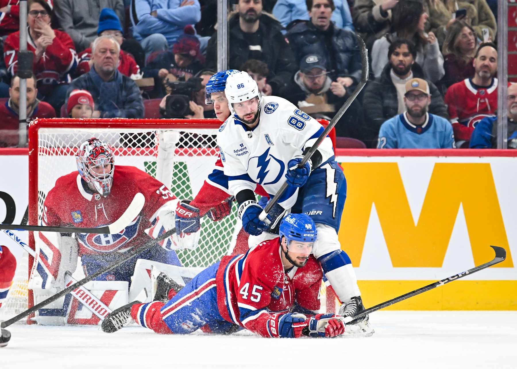 MONTREAL, CANADA - JANUARY 21:  Nikita Kucherov #86 of the Tampa Bay Lightning holds down Alexandre Carrier #45 of the Montreal Canadiens during the second period at the Bell Centre on January 21, 2025 in Montreal, Quebec, Canada.  (Photo by Minas Panagiotakis/Getty Images)