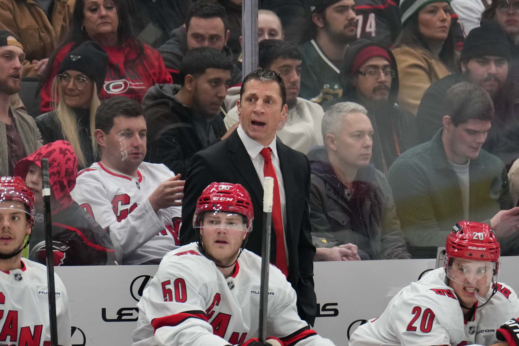 DALLAS, TX - JANUARY 21: Rod Brind'Amour watches the action from behind the bench against the Dallas Stars at the American Airlines Center on January 21, 2025 in Dallas, Texas. (Photo by Glenn James/NHLI via Getty Images)