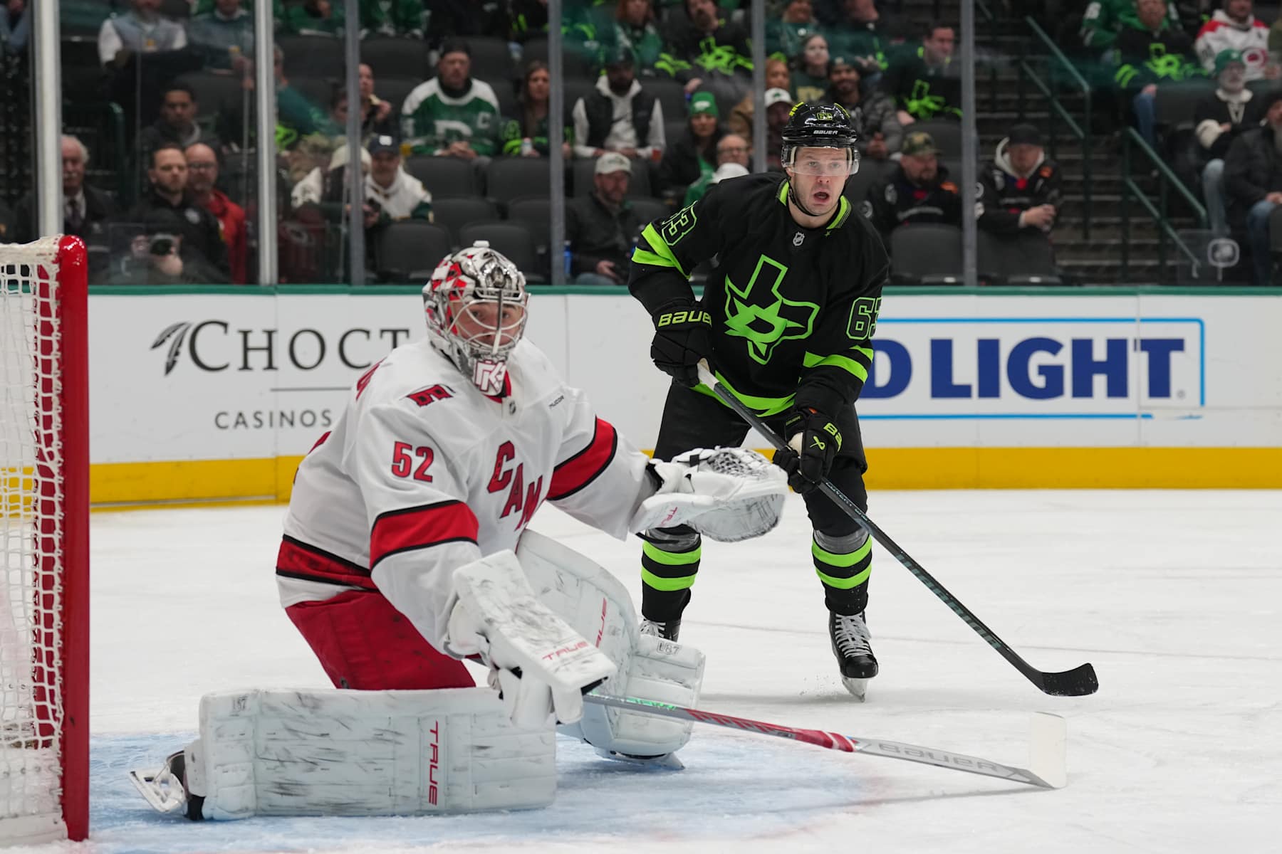 DALLAS, TX - JANUARY 21: Evgenii Dadonov #63 of the Dallas Stars skates against Pyotr Kochetkov #52 of the Carolina Hurricanes tends goal at the American Airlines Center on January 21, 2025 in Dallas, Texas. (Photo by Glenn James/NHLI via Getty Images)
