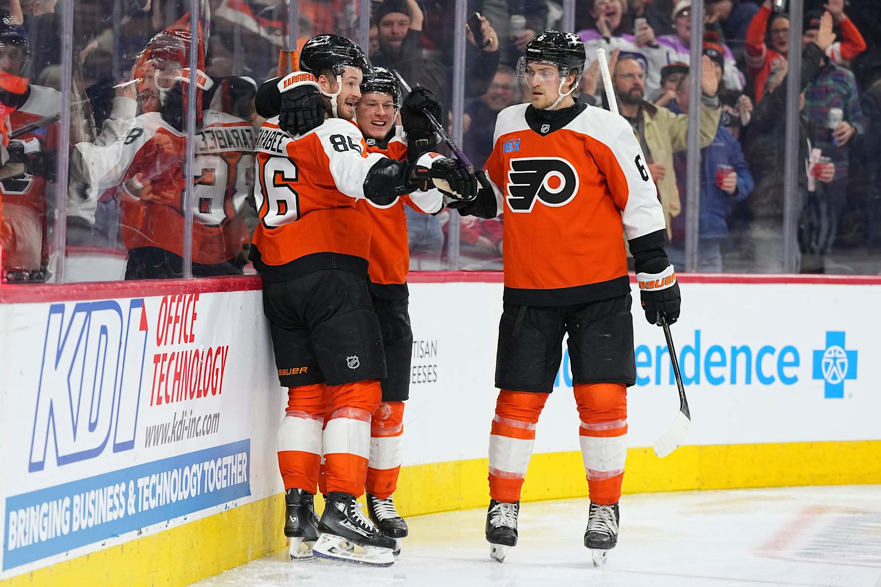 PHILADELPHIA, PENNSYLVANIA - JANUARY 21: Joel Farabee #86 of the Philadelphia Flyers celebrates with Matvei Michkov #39 and Travis Sanheim #6 after scoring a goal against the Detroit Red Wings in the second period at the Wells Fargo Center on January 21, 2025 in Philadelphia, Pennsylvania. (Photo by Mitchell Leff/Getty Images)