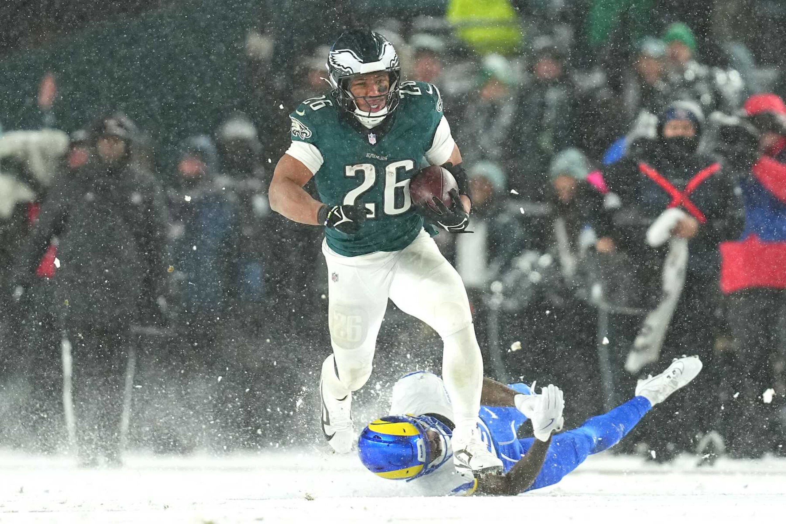 PHILADELPHIA, PENNSYLVANIA - JANUARY 19: Saquon Barkley #26 of the Philadelphia Eagles runs the ball for a 78-yard touchdown against the Los Angeles Rams during the fourth quarter in the NFC Divisional Playoff at Lincoln Financial Field on January 19, 2025 in Philadelphia, Pennsylvania. (Photo by Mitchell Leff/Getty Images) PHILADELPHIA, PENNSYLVANIA - JANUARY 19: Saquon Barkley #26 of the Philadelphia Eagles runs the ball for a 78-yard touchdown against the Los Angeles Rams during the fourth quarter in the NFC Divisional Playoff at Lincoln Financial Field on January 19, 2025 in Philadelphia, Pennsylvania. (Photo by Mitchell Leff/Getty Images)