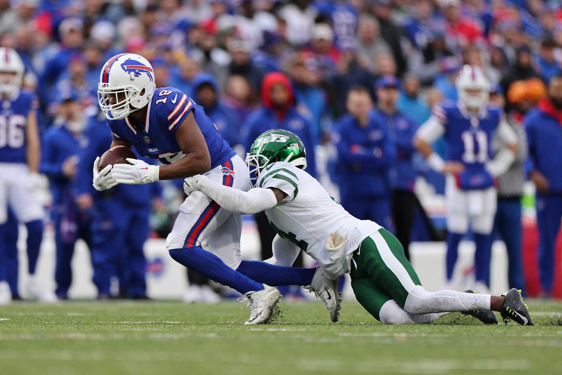 ORCHARD PARK, NEW YORK - DECEMBER 29: Amari Cooper #18 of the Buffalo Bills catches a pass in front of D.J. Reed #4 of the New York Jets during the third quarter at Highmark Stadium on December 29, 2024 in Orchard Park, New York. (Photo by Bryan M. Bennett/Getty Images)