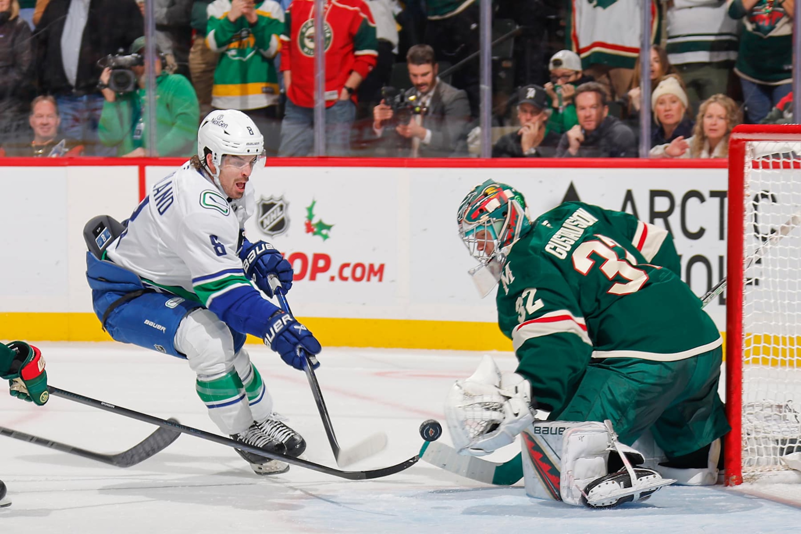 SAINT PAUL, MN - DECEMBER 3: Filip Gustavsson #32 of the Minnesota Wild makes a save against Brock Boeser #6 of the Vancouver Canucks during the game at the Xcel Energy Center on December 3, 2024 in Saint Paul, Minnesota. (Photo by Bruce Kluckhohn/NHLI via Getty Images) SAINT PAUL, MN - DECEMBER 3: Filip Gustavsson #32 of the Minnesota Wild makes a save against Brock Boeser #6 of the Vancouver Canucks during the game at the Xcel Energy Center on December 3, 2024 in Saint Paul, Minnesota. (Photo by Bruce Kluckhohn/NHLI via Getty Images)