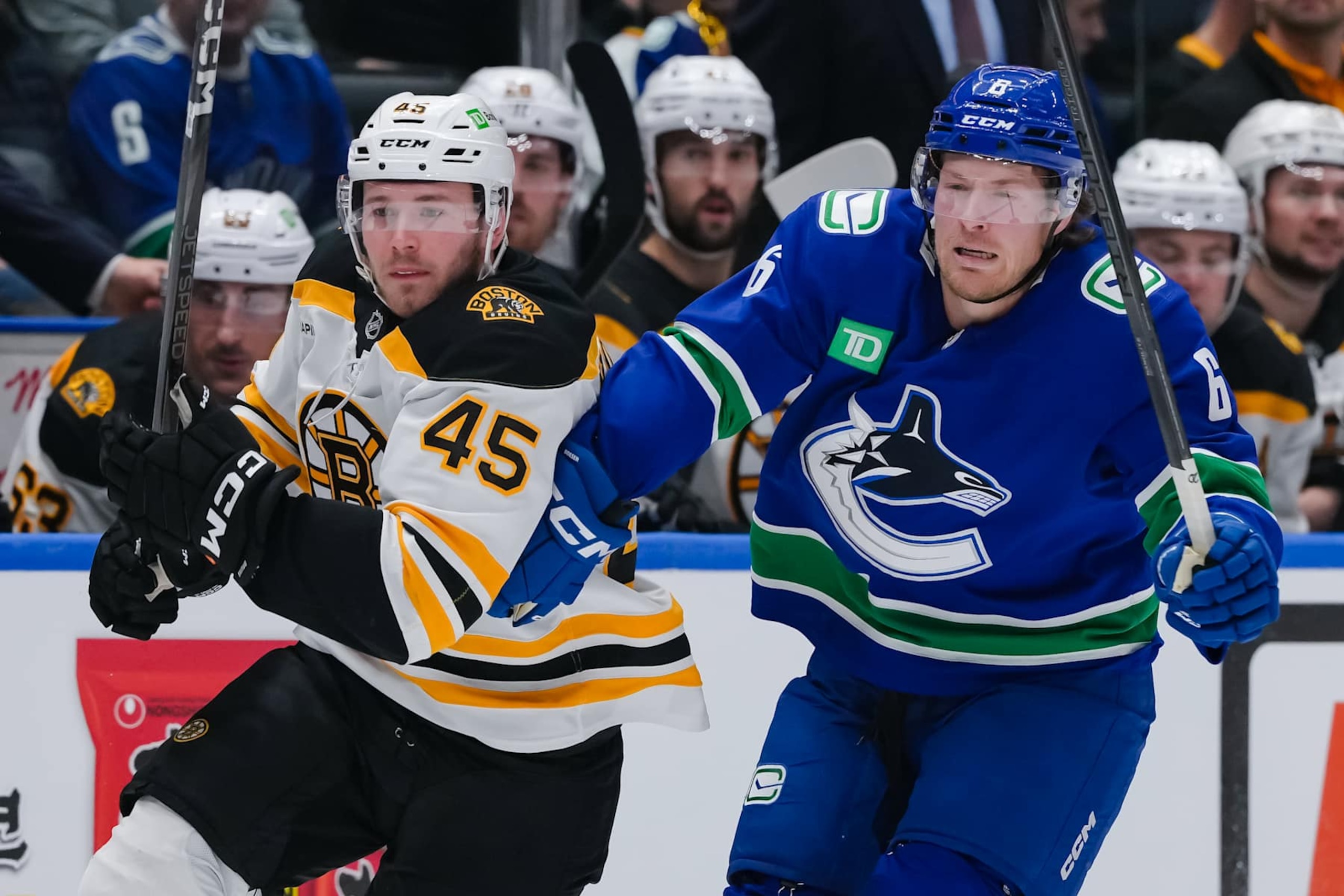 VANCOUVER, CANADA - DECEMBER 14: Cole Koepke #45 of the Boston Bruins and Brock Boeser #6 of the Vancouver Canucks skate during the second period of their NHL game at Rogers Arena on December 14, 2024 in Vancouver, British Columbia, Canada. (Photo by Derek Cain/Getty Images) VANCOUVER, CANADA - DECEMBER 14: Cole Koepke #45 of the Boston Bruins and Brock Boeser #6 of the Vancouver Canucks skate during the second period of their NHL game at Rogers Arena on December 14, 2024 in Vancouver, British Columbia, Canada. (Photo by Derek Cain/Getty Images)