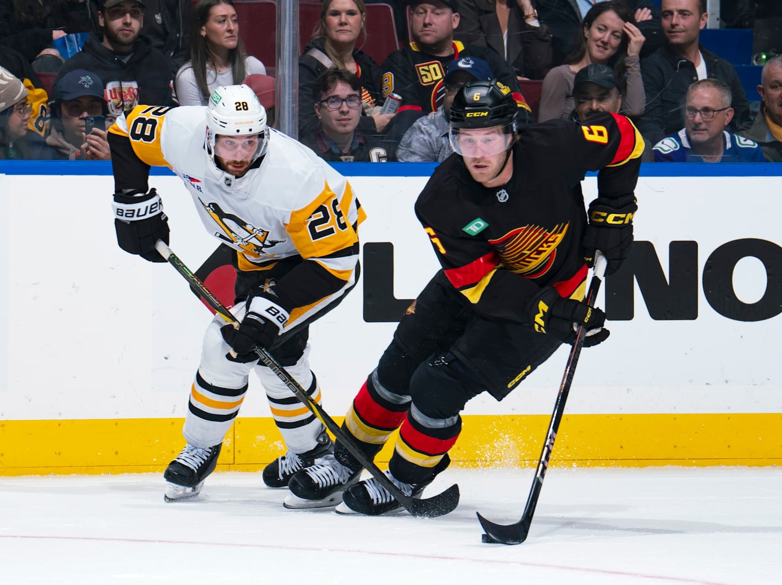 VANCOUVER, CANADA - OCTOBER 26: Marcus Pettersson #28 of the Pittsburgh Penguins checks Brock Boeser #6 of the Vancouver Canucks during their NHL game at Rogers Arena on October 26, 2024 in Vancouver, British Columbia, Canada. (Photo by Jeff Vinnick/NHLI via Getty Images) VANCOUVER, CANADA - OCTOBER 26: Marcus Pettersson #28 of the Pittsburgh Penguins checks Brock Boeser #6 of the Vancouver Canucks during their NHL game at Rogers Arena on October 26, 2024 in Vancouver, British Columbia, Canada. (Photo by Jeff Vinnick/NHLI via Getty Images)