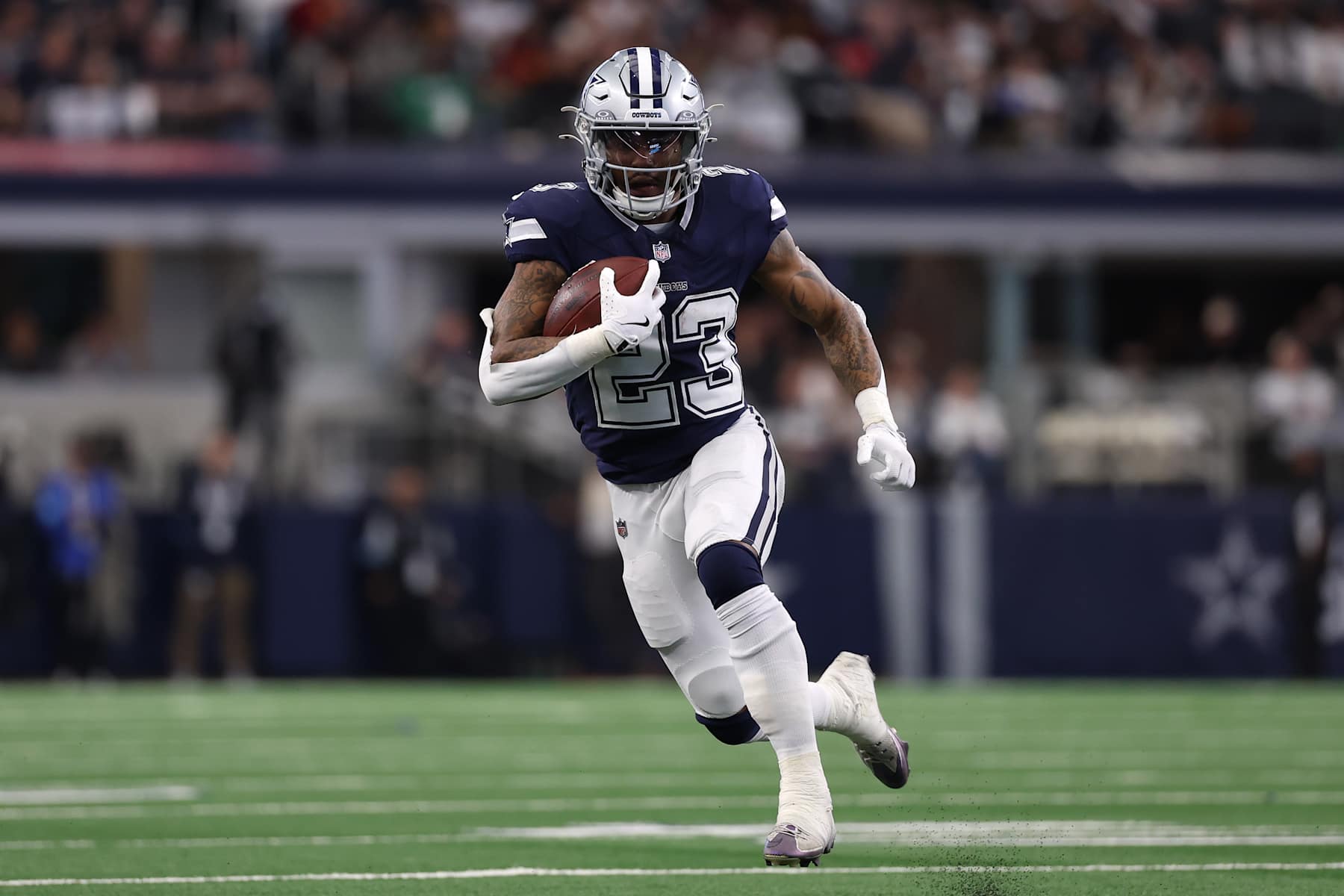 ARLINGTON, TEXAS - JANUARY 05: Rico Dowdle #23 of the Dallas Cowboys runs with the ball during the second quarter against the Washington Commanders at AT&T Stadium on January 05, 2025 in Arlington, Texas. (Photo by Sam Hodde/Getty Images)