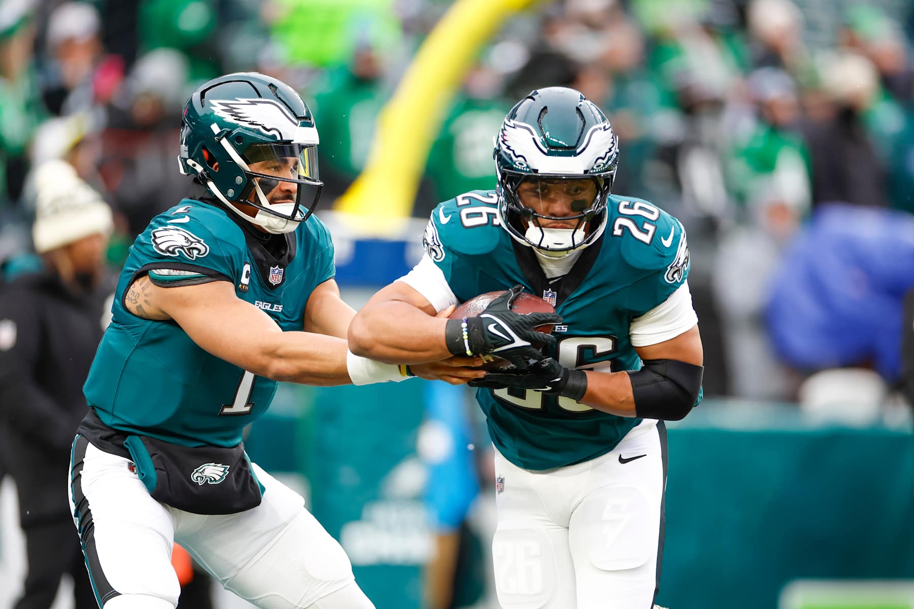 PHILADELPHIA, PENNSYLVANIA - JANUARY 19: Jalen Hurts #1 of the Philadelphia Eagles warms up with Saquon Barkley #26 prior to the NFC Divisional Playoff game against the Los Angeles Rams at Lincoln Financial Field on January 19, 2025 in Philadelphia, Pennsylvania. (Photo by Brandon Sloter/Getty Images)