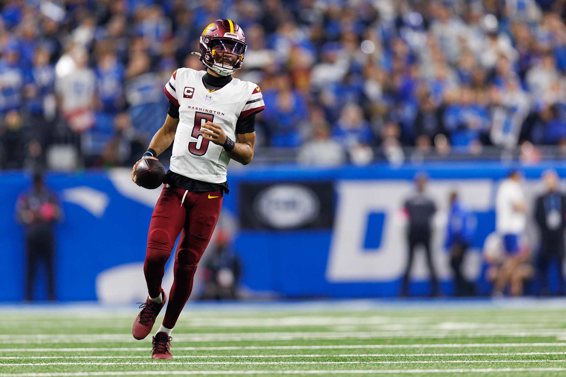 DETROIT, MICHIGAN - JANUARY 18: Quarterback Jayden Daniels #5 of the Washington Commanders runs downfield during the first half of an NFL football divisional playoff game against the Detroit Lions, at Ford Field on January 18, 2025 in Detroit, Michigan. (Photo by Brooke Sutton/Getty Images)