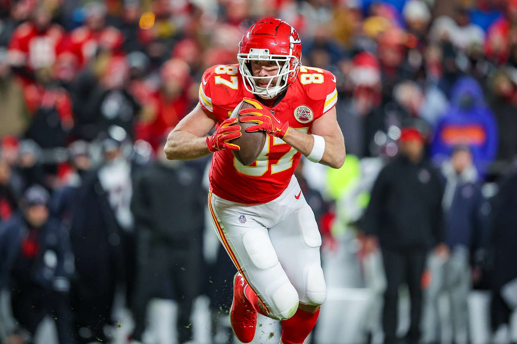 KANSAS CITY, MISSOURI - JANUARY 18: Travis Kelce #87 of the Kansas City Chiefs runs for yardage after a third quarter pass catch in the Divisional Round playoff at GEHA Field at Arrowhead Stadium on January 18, 2025 in Kansas City, Missouri. (Photo by David Eulitt/Getty Images)