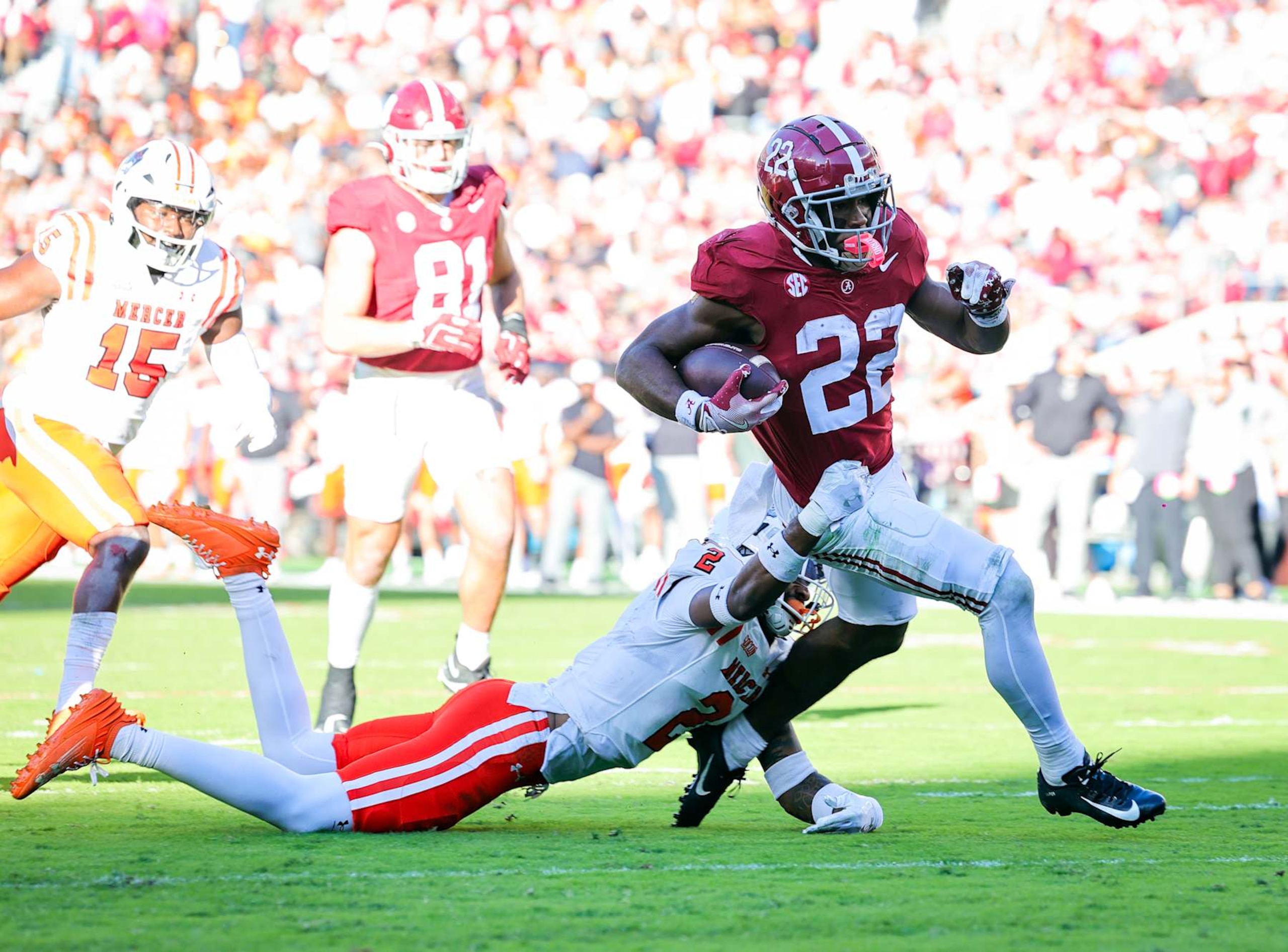 TUSCALOOSA, ALABAMA - NOVEMBER 16: Justice Haynes #22 of the Alabama Crimson Tide runs through a second half tackle attempt from Myles Redding #2 of the Mercer Bears at Bryant-Denny Stadium on November 16, 2024 in Tuscaloosa, Alabama. (Photo by Brandon Sumrall/Getty Images)
