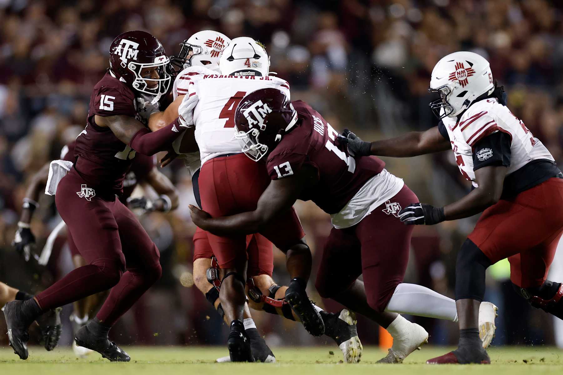 COLLEGE STATION, TEXAS - NOVEMBER 16: DJ Hicks #13 of the Texas A&M Aggies tackles Mike Washington #4 of the New Mexico State Aggies in the second half at Kyle Field on November 16, 2024 in College Station, Texas. (Photo by Tim Warner/Getty Images)