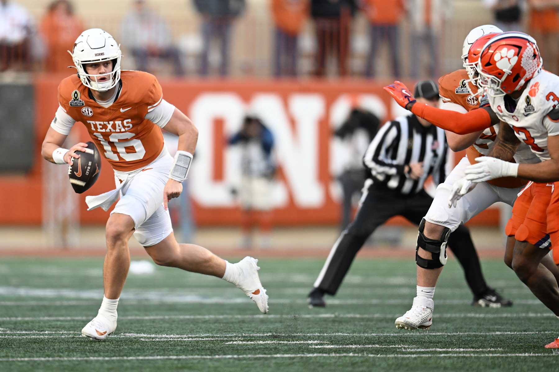 AUSTIN, TEXAS - DECEMBER 21: Arch Manning #16 of the Texas Longhorns scrambles with the ball during the third quarter against the Clemson Tigers in the Playoff First Round Game at Darrell K Royal-Texas Memorial Stadium on December 21, 2024 in Austin, Texas. (Photo by Jack Gorman/Getty Images)