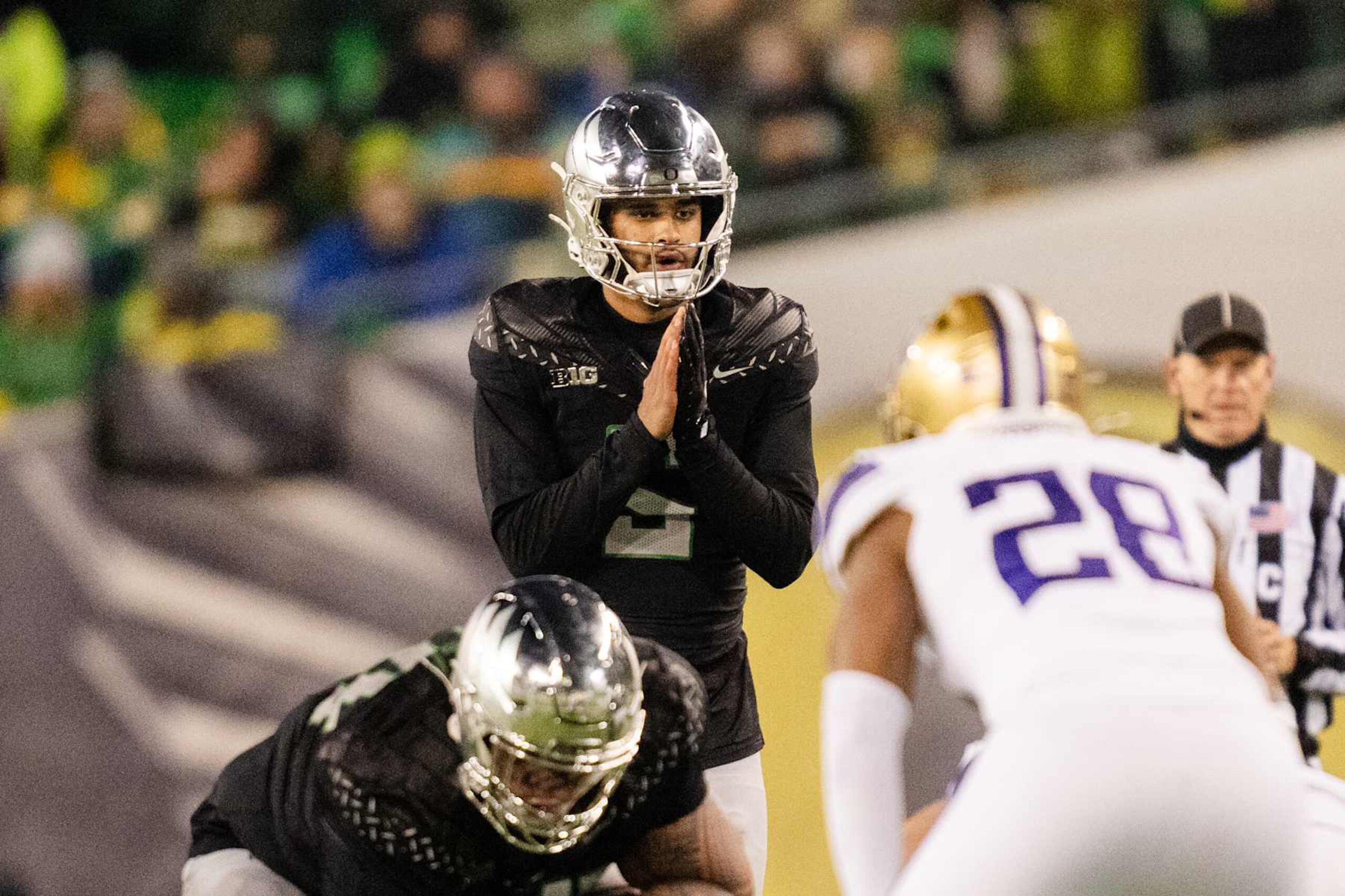 EUGENE, OREGON - NOVEMBER 30:  Quarterback Dante Moore #5 of the Oregon Ducks calls out a play during the second half of the game against the Washington Huskies at Autzen Stadium on November 30, 2024 in Eugene, Oregon. (Photo by Ali Gradischer/Getty Images)