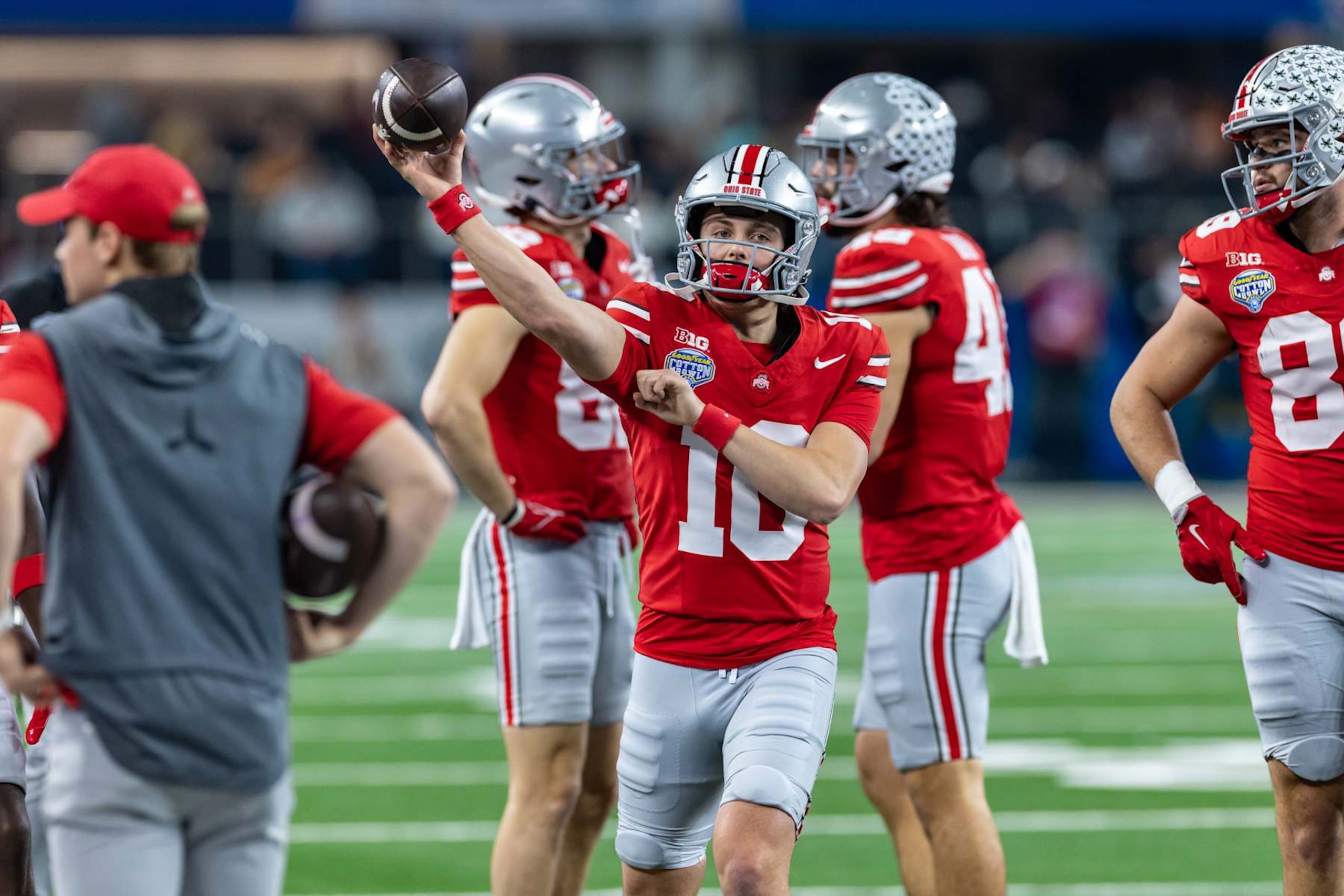 ARLINGTON, TX - JANUARY 10: Ohio State Buckeyes quarterback Julian Sayin (#10) warms up on the sideline during the CFP Semifinal Cotton Bowl Classic football game between the Ohio State Buckeyes and Texas Longhorns on January 10, 2025 at AT&T Stadium in Arlington, TX.  (Photo by Matthew Visinsky/Icon Sportswire via Getty Images)
