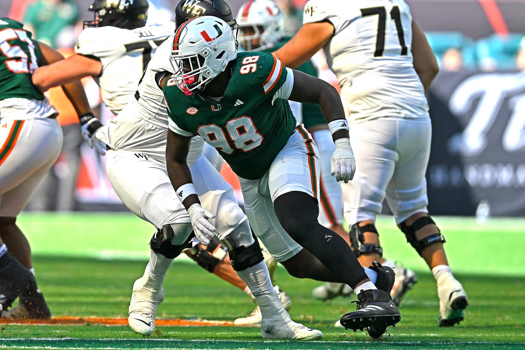 MIAMI GARDENS, FL - NOVEMBER 23:  Miami defensive lineman Justin Scott (98) pursues the ball carrier in the second quarter as the Miami Hurricanes faced the Wake Forest Demon Deacons on November 23, 2024, at Hard Rock Stadium in Miami Gardens, Florida. (Photo by Samuel Lewis/Icon Sportswire via Getty Images)