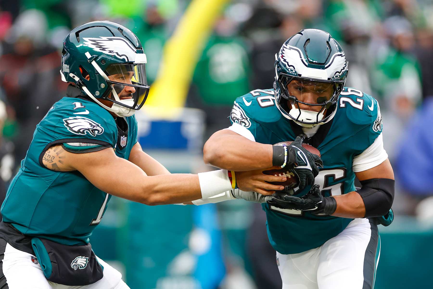 PHILADELPHIA, PENNSYLVANIA - JANUARY 19: Jalen Hurts #1 of the Philadelphia Eagles hands the ball off to Saquon Barkley #26 in warm ups prior to the NFC Divisional Playoff game against the Los Angeles Rams at Lincoln Financial Field on January 19, 2025 in Philadelphia, Pennsylvania. (Photo by Brandon Sloter/Getty Images)