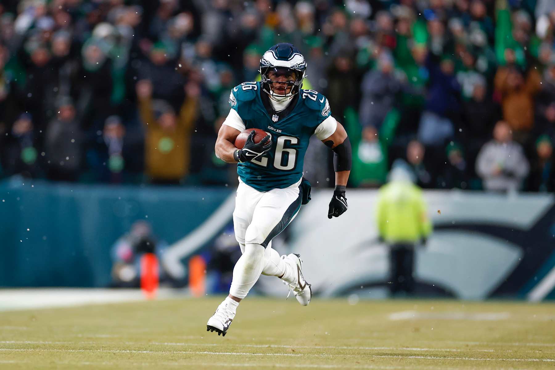 PHILADELPHIA, PENNSYLVANIA - JANUARY 19: Saquon Barkley #26 of the Philadelphia Eagles carries the ball on a running play for a touchdown during the first half of the NFC Divisional Playoff game against the Los Angeles Rams at Lincoln Financial Field on January 19, 2025 in Philadelphia, Pennsylvania. (Photo by Brandon Sloter/Getty Images)