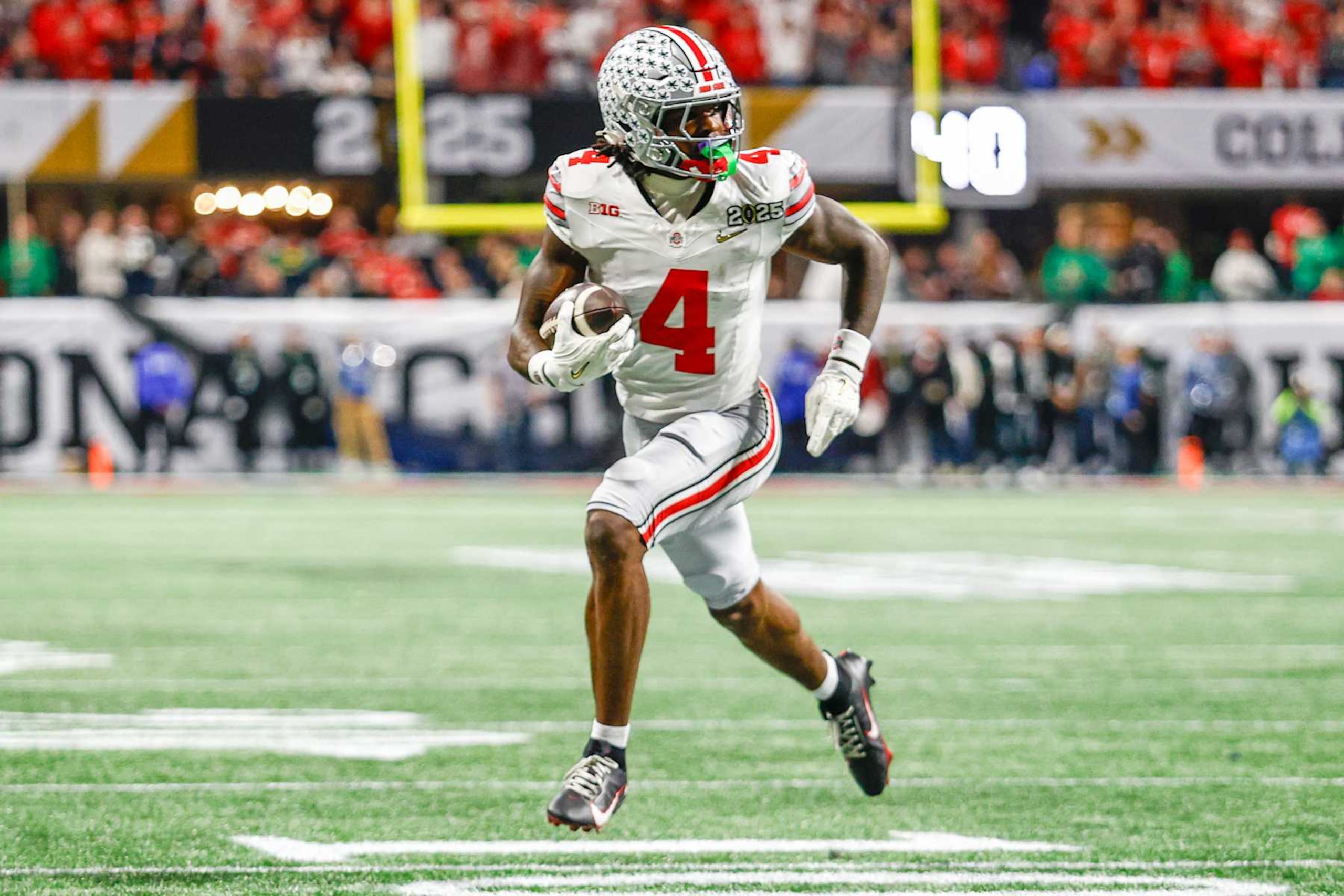 ATLANTA, GEORGIA - JANUARY 20: Jeremiah Smith #4 of Ohio State runs for a touchdown during the National Championship game between Ohio State and Notre Dame at Mercedes-Benz Stadium on January 20, 2025 in Atlanta, GA. (Photo by Michael Miller/ISI Photos/Getty Images) ATLANTA, GEORGIA - JANUARY 20: Jeremiah Smith #4 of Ohio State runs for a touchdown during the National Championship game between Ohio State and Notre Dame at Mercedes-Benz Stadium on January 20, 2025 in Atlanta, GA. (Photo by Michael Miller/ISI Photos/Getty Images)