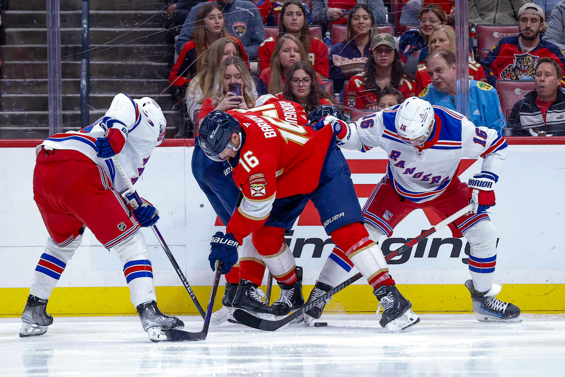 SUNRISE, FL - DECEMBER 30: Florida Panther Aleksander Barkov #16 (C) battles for the puck with New York Ranger Vincent Trocheck #16 (R) during the game between New York Rangers and the Florida Panthers on Monday December 30, 2024, at Amerant Bank Arena in Sunrise, FL. (Photo by Chris Arjoon/Icon Sportswire via Getty Images)
