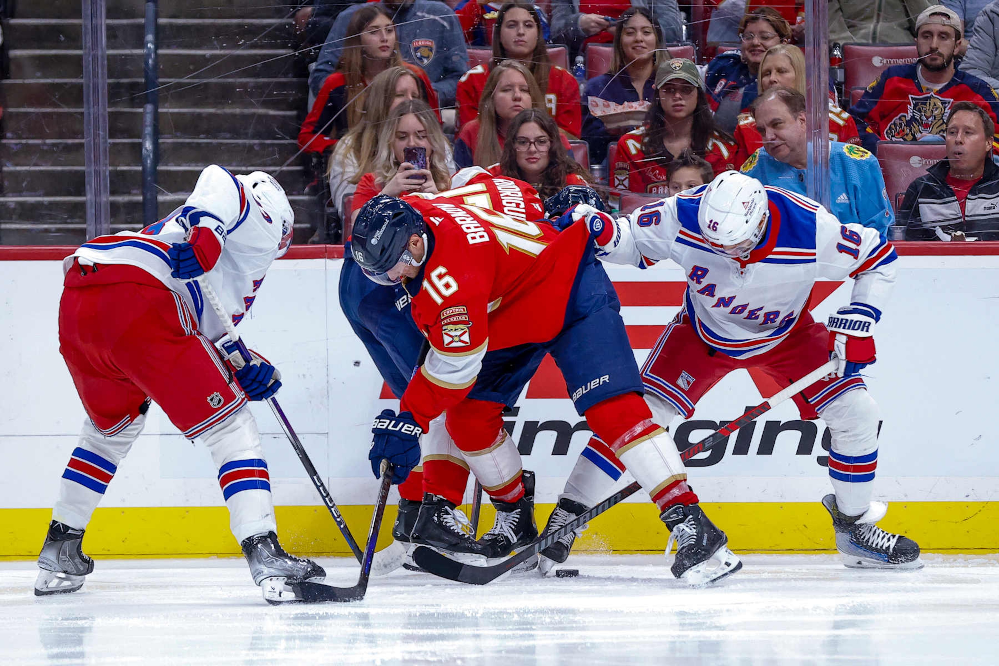 SUNRISE, FL - DECEMBER 30: Florida Panther Aleksander Barkov #16 (C) battles for the puck with New York Ranger Vincent Trocheck #16 (R) during the game between New York Rangers and the Florida Panthers on Monday December 30, 2024, at Amerant Bank Arena in Sunrise, FL. (Photo by Chris Arjoon/Icon Sportswire via Getty Images) SUNRISE, FL - DECEMBER 30: Florida Panther Aleksander Barkov #16 (C) battles for the puck with New York Ranger Vincent Trocheck #16 (R) during the game between New York Rangers and the Florida Panthers on Monday December 30, 2024, at Amerant Bank Arena in Sunrise, FL. (Photo by Chris Arjoon/Icon Sportswire via Getty Images)