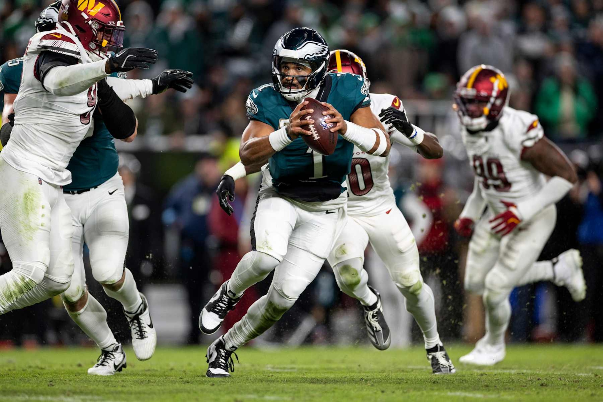 PHILADELPHIA, PENNSYLVANIA - NOVEMBER 14: Jalen Hurts #1 of the Philadelphia Eagles scrambles and looks to pass during an NFL Football game against the Washington Commanders at Lincoln Financial Field on November 14, 2024 in Philadelphia, Pennsylvania. (Photo by Michael Owens/Getty Images) PHILADELPHIA, PENNSYLVANIA - NOVEMBER 14: Jalen Hurts #1 of the Philadelphia Eagles scrambles and looks to pass during an NFL Football game against the Washington Commanders at Lincoln Financial Field on November 14, 2024 in Philadelphia, Pennsylvania. (Photo by Michael Owens/Getty Images)