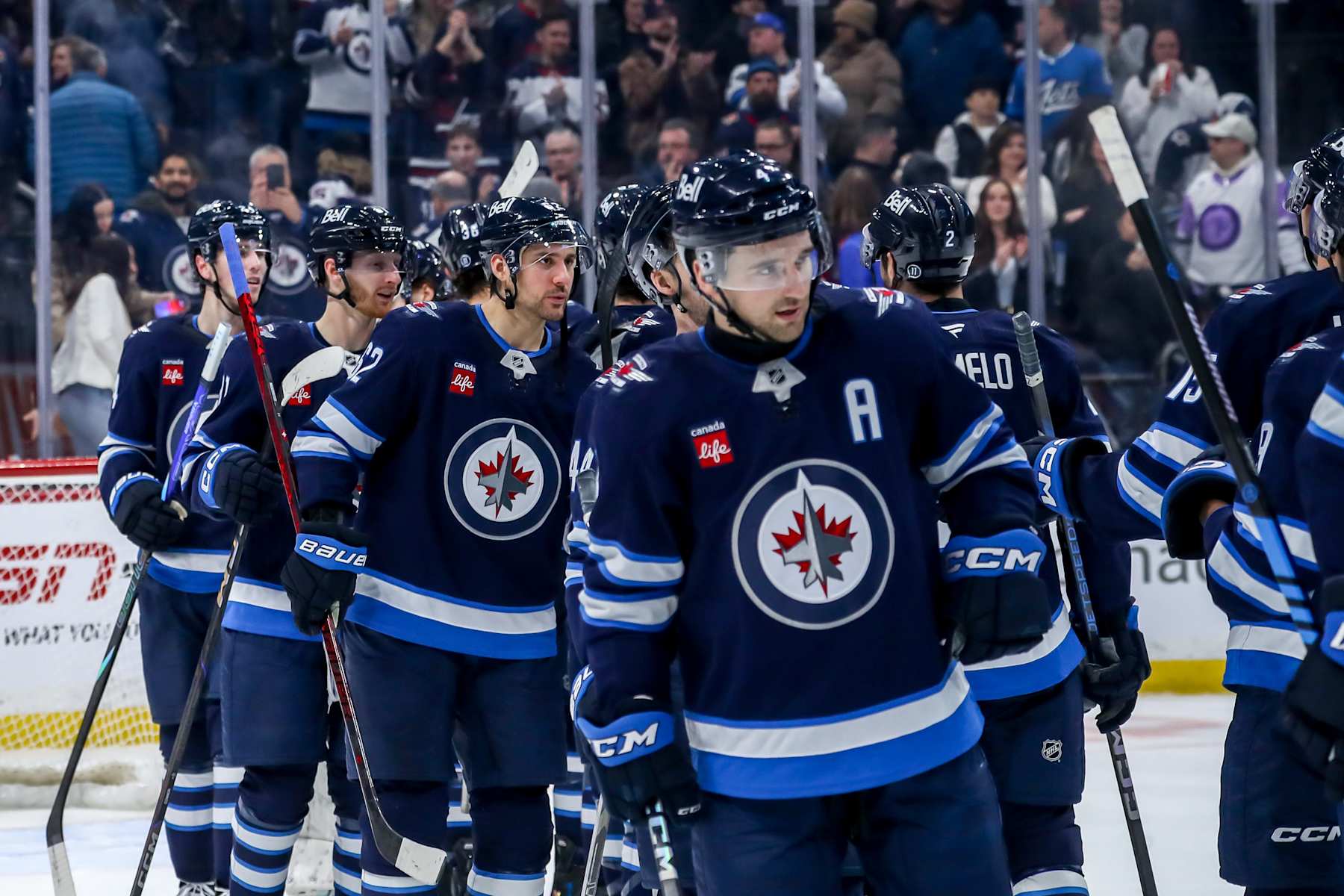 WINNIPEG, CANADA - JANUARY 24: Winnipeg Jets players celebrate on the ice following a 5-2 victory over the Utah Hockey Club at the Canada Life Centre on January 24, 2025 in Winnipeg, Manitoba, Canada. (Photo by Darcy Finley/NHLI via Getty Images)