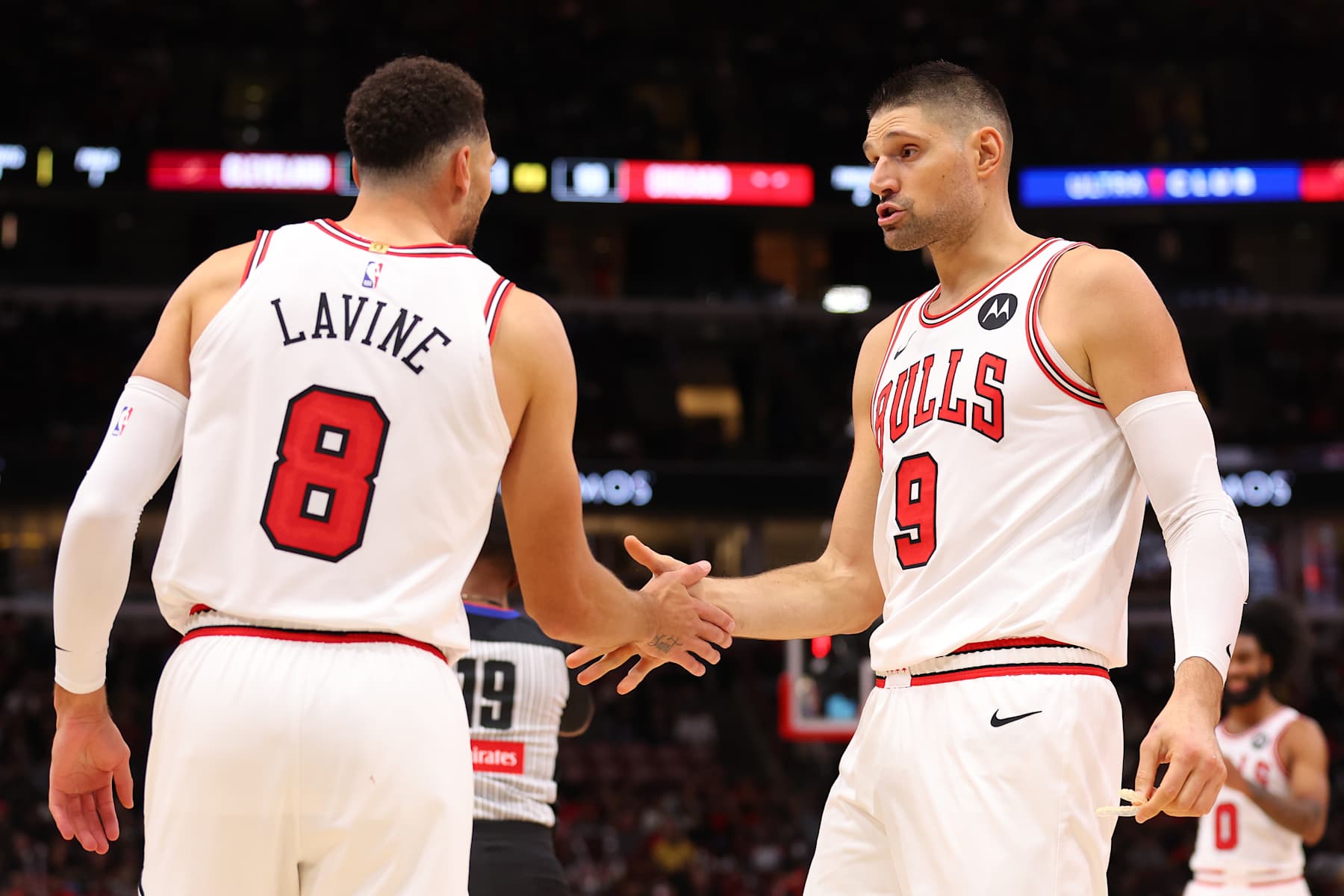 CHICAGO, ILLINOIS - OCTOBER 18: Zach LaVine #8 and Nikola Vucevic #9 of the Chicago Bulls high five against the Cleveland Cavaliers during the second half of a preseason game at the United Center on October 18, 2024 in Chicago, Illinois. NOTE TO USER: User expressly acknowledges and agrees that, by downloading and or using this photograph, User is consenting to the terms and conditions of the Getty Images License Agreement.  (Photo by Michael Reaves/Getty Images)