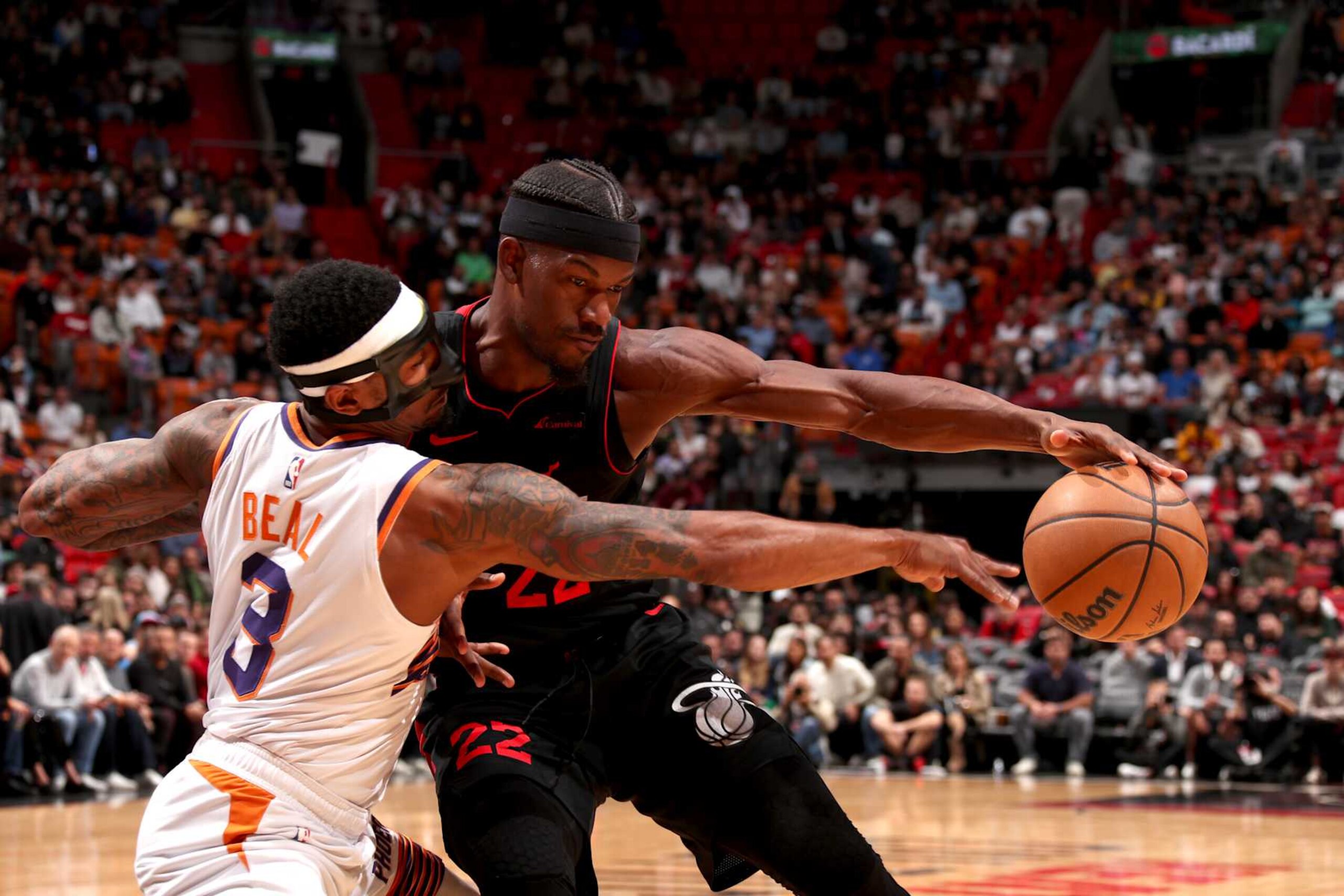 MIAMI, FL - JANUARY 29: Jimmy Butler #22 of the Miami Heat handles the ball while Bradley Beal #3 of the Phoenix Suns goes for the steal during the game on January 29, 2024 at Kaseya Center in Miami, Florida. NOTE TO USER: User expressly acknowledges and agrees that, by downloading and or using this Photograph, user is consenting to the terms and conditions of the Getty Images License Agreement. Mandatory Copyright Notice: Copyright 2024 NBAE (Photo by Issac Baldizon/NBAE via Getty Images) MIAMI, FL - JANUARY 29: Jimmy Butler #22 of the Miami Heat handles the ball while Bradley Beal #3 of the Phoenix Suns goes for the steal during the game on January 29, 2024 at Kaseya Center in Miami, Florida. NOTE TO USER: User expressly acknowledges and agrees that, by downloading and or using this Photograph, user is consenting to the terms and conditions of the Getty Images License Agreement. Mandatory Copyright Notice: Copyright 2024 NBAE (Photo by Issac Baldizon/NBAE via Getty Images)