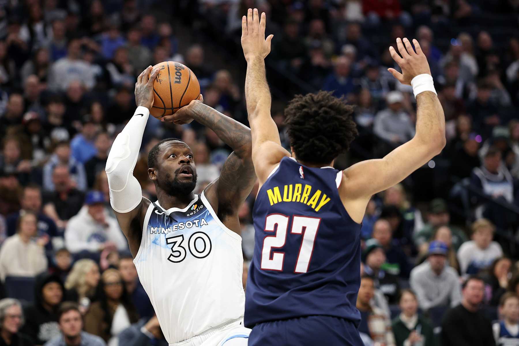 MINNEAPOLIS, MINNESOTA - JANUARY 25: Julius Randle #30 of the Minnesota Timberwolves shoots against Jamal Murray #27 of the Denver Nuggets during the first quarter at Target Center on January 25, 2025 in Minneapolis, Minnesota. NOTE TO USER: User expressly acknowledges and agrees that, by downloading and or using this photograph, User is consenting to the terms and conditions of the Getty Images License Agreement. (Photo by Matt Krohn/Getty Images)
