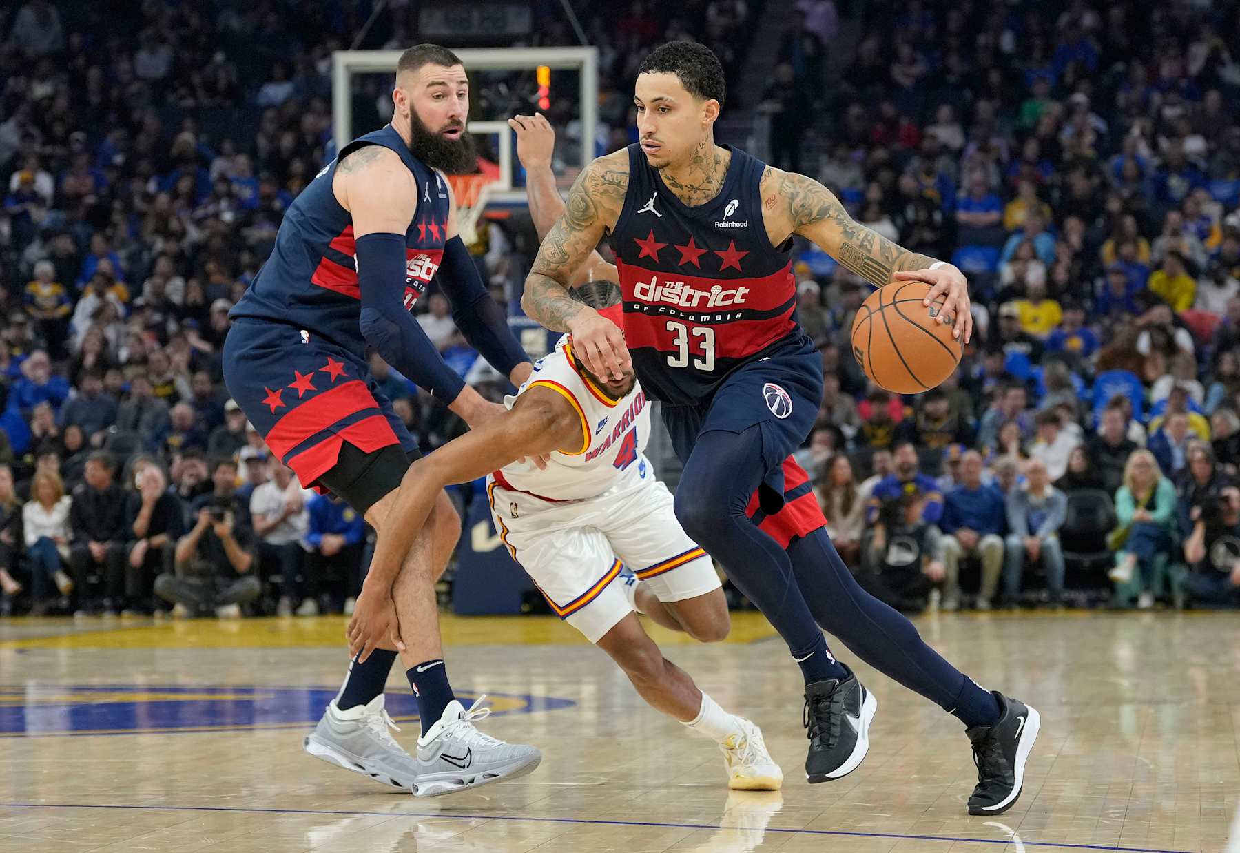 SAN FRANCISCO, CALIFORNIA - JANUARY 18: Kyle Kuzma #33 of the Washington Wizards dribbles around a screen set by Jonas Valanciunas #17 on Moses Moody #4 of the Golden State Warriors during the first half of an NBA basketball game at Chase Center on January 18, 2025 in San Francisco, California. NOTE TO USER: User expressly acknowledges and agrees that, by downloading and or using this photograph, User is consenting to the terms and conditions of the Getty Images License Agreement. (Photo by Thearon W. Henderson/Getty Images)