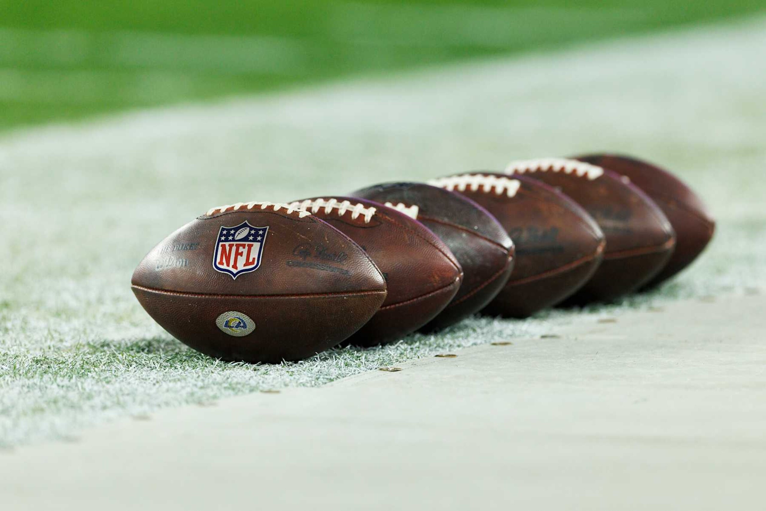 GLENDALE, ARIZONA - JANUARY 13: A detail view of a row of NFL footballs on the sideline before the NFC Wild Card Playoff game between the Minnesota Vikings and the Los Angeles Rams at State Farm Stadium on January 13, 2025 in Glendale, Arizona. (Photo by Ric Tapia/Getty Images) GLENDALE, ARIZONA - JANUARY 13: A detail view of a row of NFL footballs on the sideline before the NFC Wild Card Playoff game between the Minnesota Vikings and the Los Angeles Rams at State Farm Stadium on January 13, 2025 in Glendale, Arizona. (Photo by Ric Tapia/Getty Images)