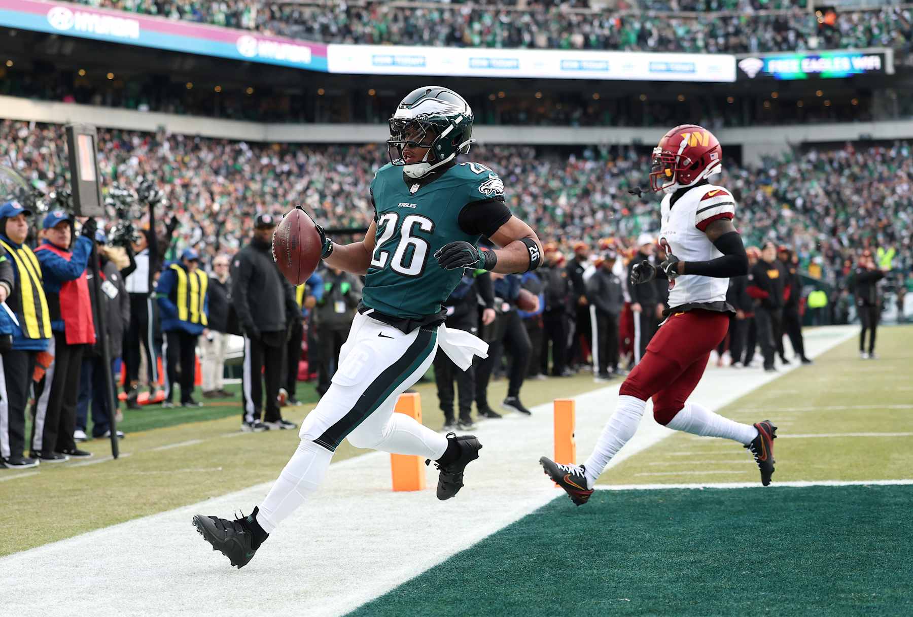 PHILADELPHIA, PENNSYLVANIA - JANUARY 26: Saquon Barkley #26 of the Philadelphia Eagles scores a 4 yard touchdown against the Washington Commanders during the first quarter in the NFC Championship Game at Lincoln Financial Field on January 26, 2025 in Philadelphia, Pennsylvania.  (Photo by Emilee Chinn/Getty Images)