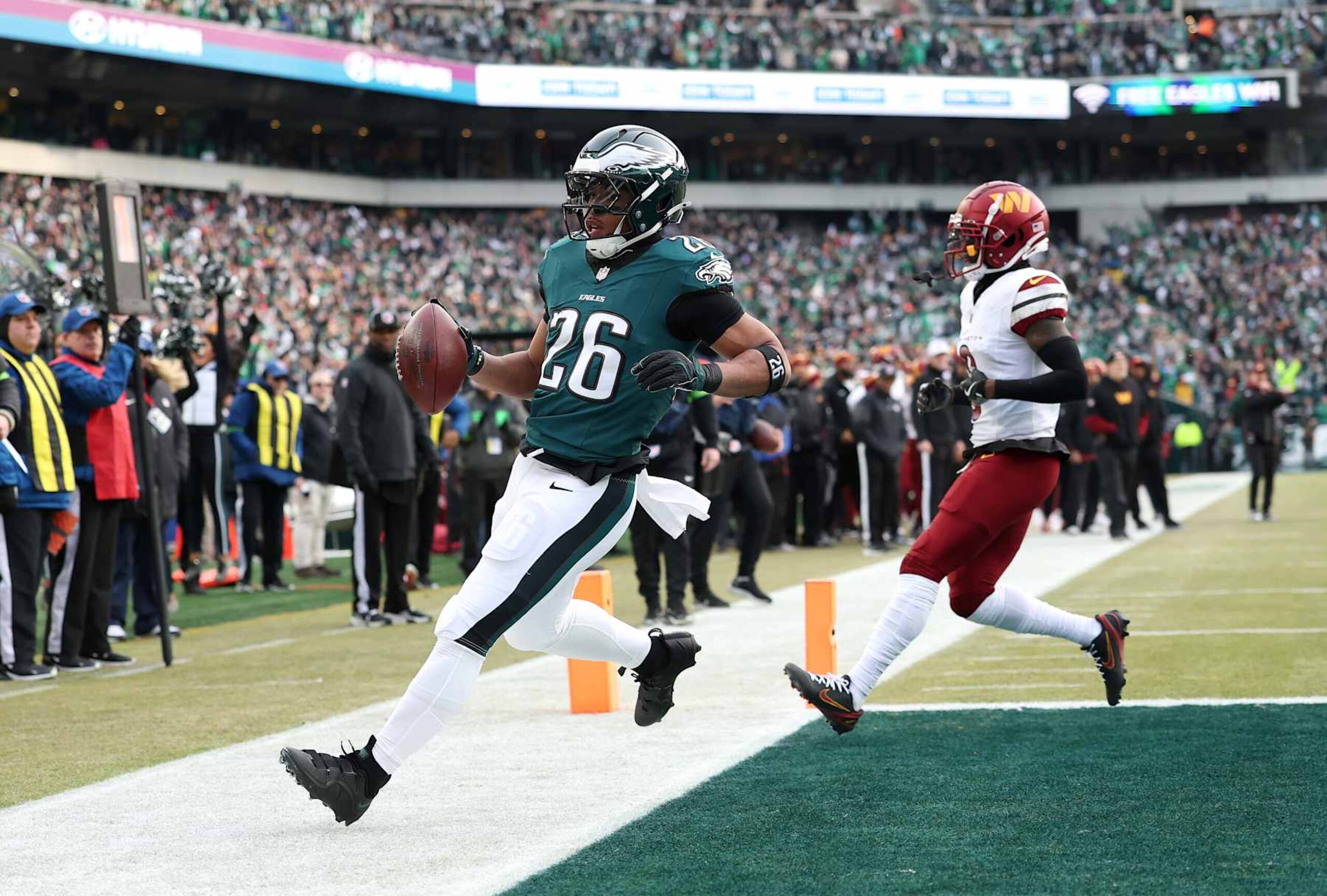 PHILADELPHIA, PENNSYLVANIA - JANUARY 26: Saquon Barkley #26 of the Philadelphia Eagles scores a 4 yard touchdown against the Washington Commanders during the first quarter in the NFC Championship Game at Lincoln Financial Field on January 26, 2025 in Philadelphia, Pennsylvania.  (Photo by Emilee Chinn/Getty Images)