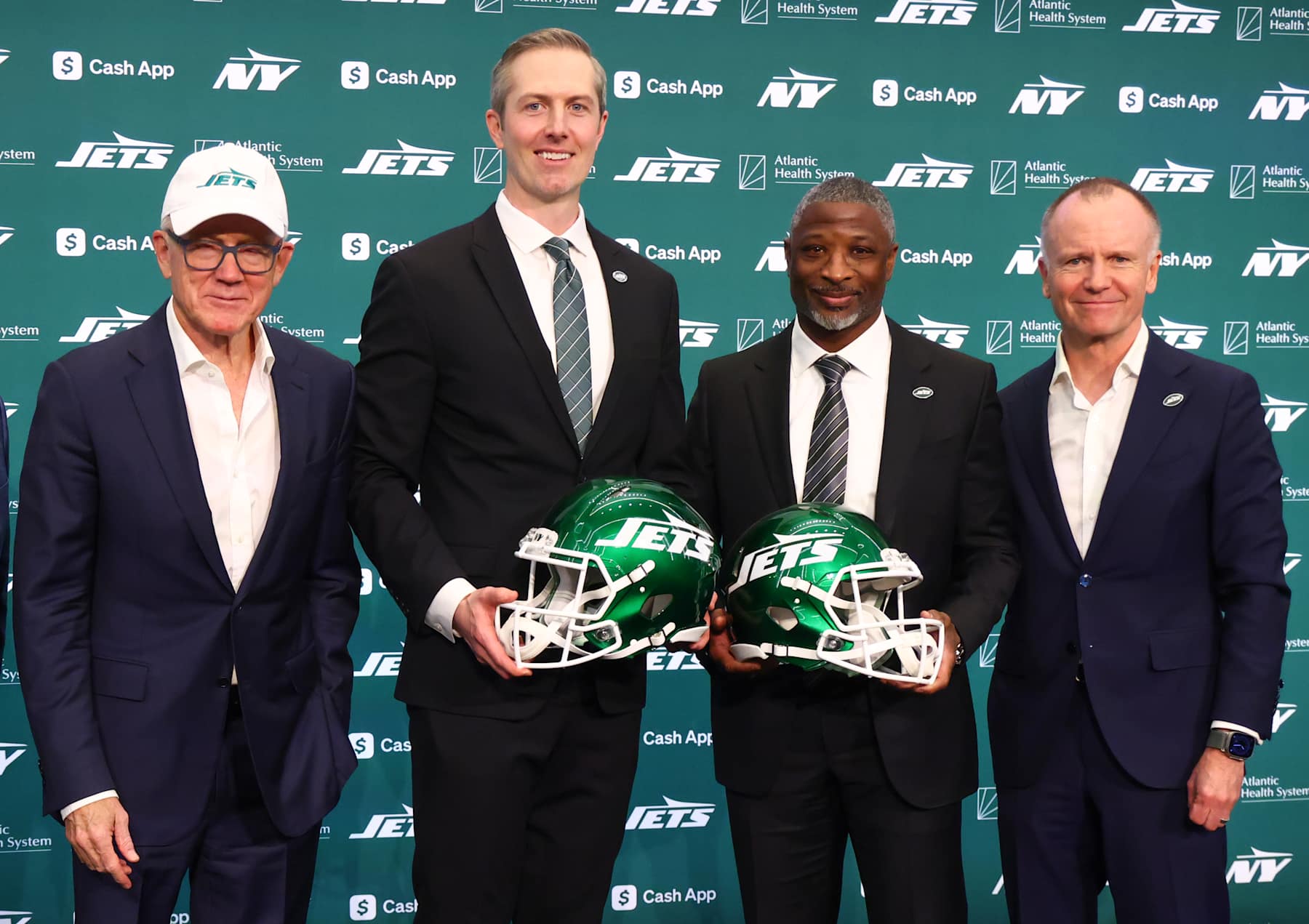 FLORHAM PARK, NEW JERSEY - JANUARY 27: (L to R) New York Jets co-owner Woody Johnson, general manager Darren Mougey, head coach Aaron Glenn and co-owner Christopher Johnson pose after the press conference announcing the hirings of Mougey and Glenn at Atlantic Health Jets Training Center on January 27, 2025 in Florham Park, New Jersey. (Photo by Ed Mulholland/Getty Images)