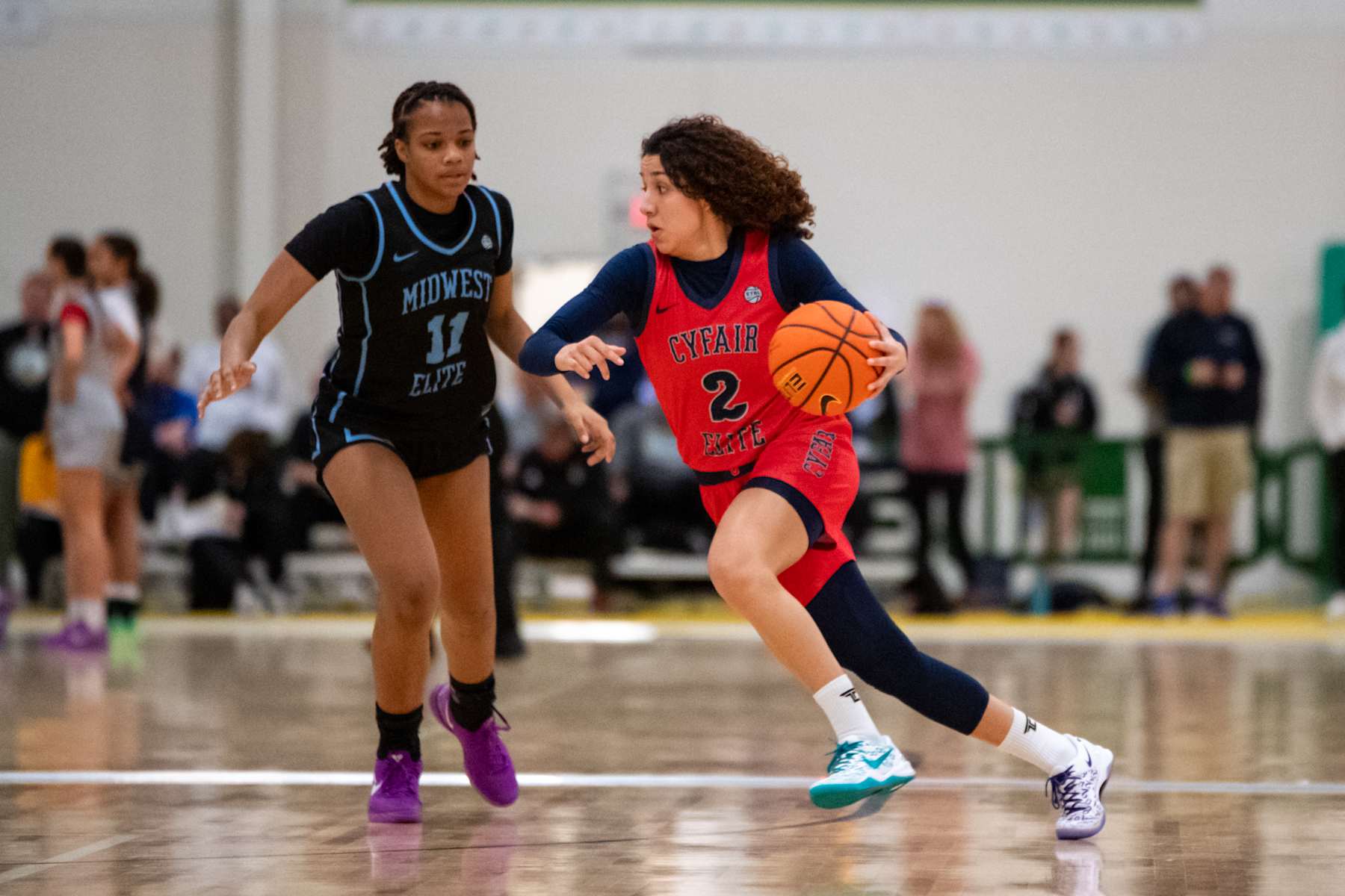 Aaliyah Chavez, right, dribbles around Midwest Elite defender Xyanna Walton, left, during a game at the Boo Williams Sports Complex on Friday, April 19, 2024, in Hampton, Va. (Photo by Mike Caudill/for The Washington Post via Getty Images)