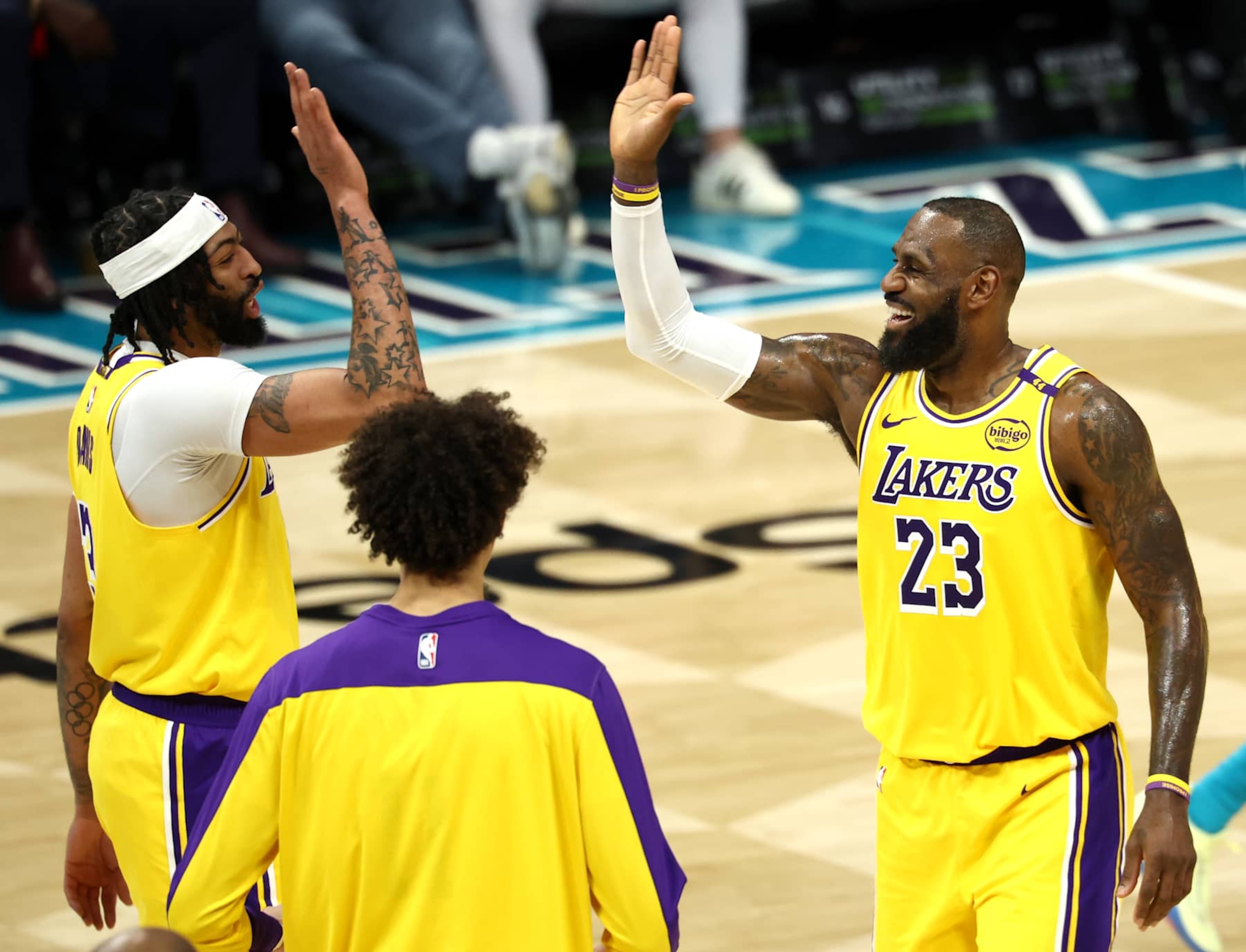 CHARLOTTE, NORTH CAROLINA - JANUARY 27: LeBron James #23 and Anthony Davis #3 of the Los Angeles Lakers react during the first half of the game against the Charlotte Hornets at Spectrum Center on January 27, 2025 in Charlotte, North Carolina. NOTE TO USER: User expressly acknowledges and agrees that, by downloading and or using this photograph, User is consenting to the terms and conditions of the Getty Images License Agreement. (Photo by Jared C. Tilton/Getty Images)