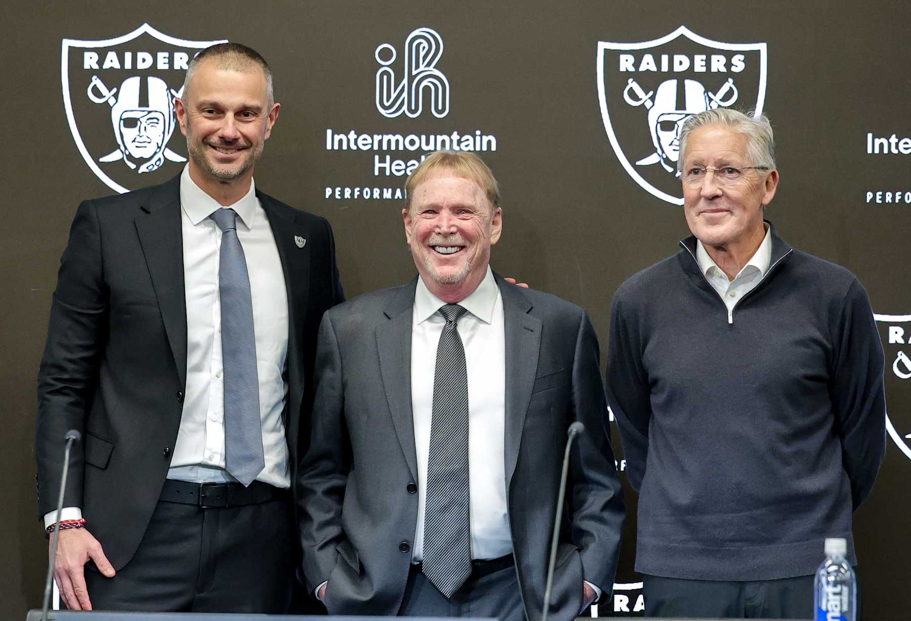 HENDERSON, NEVADA - JANUARY 27: Owner and managing general partner Mark Davis (C) of the Las Vegas Raiders poses for photos with John Spytek (L) and Pete Carroll (R) during a news conference introducing Spytek as the general manager and Carroll as the head coach of the Raiders at the Las Vegas Raiders Headquarters/Intermountain Healthcare Performance Center on January 27, 2025 in Henderson, Nevada. (Photo by Ethan Miller/Getty Images)