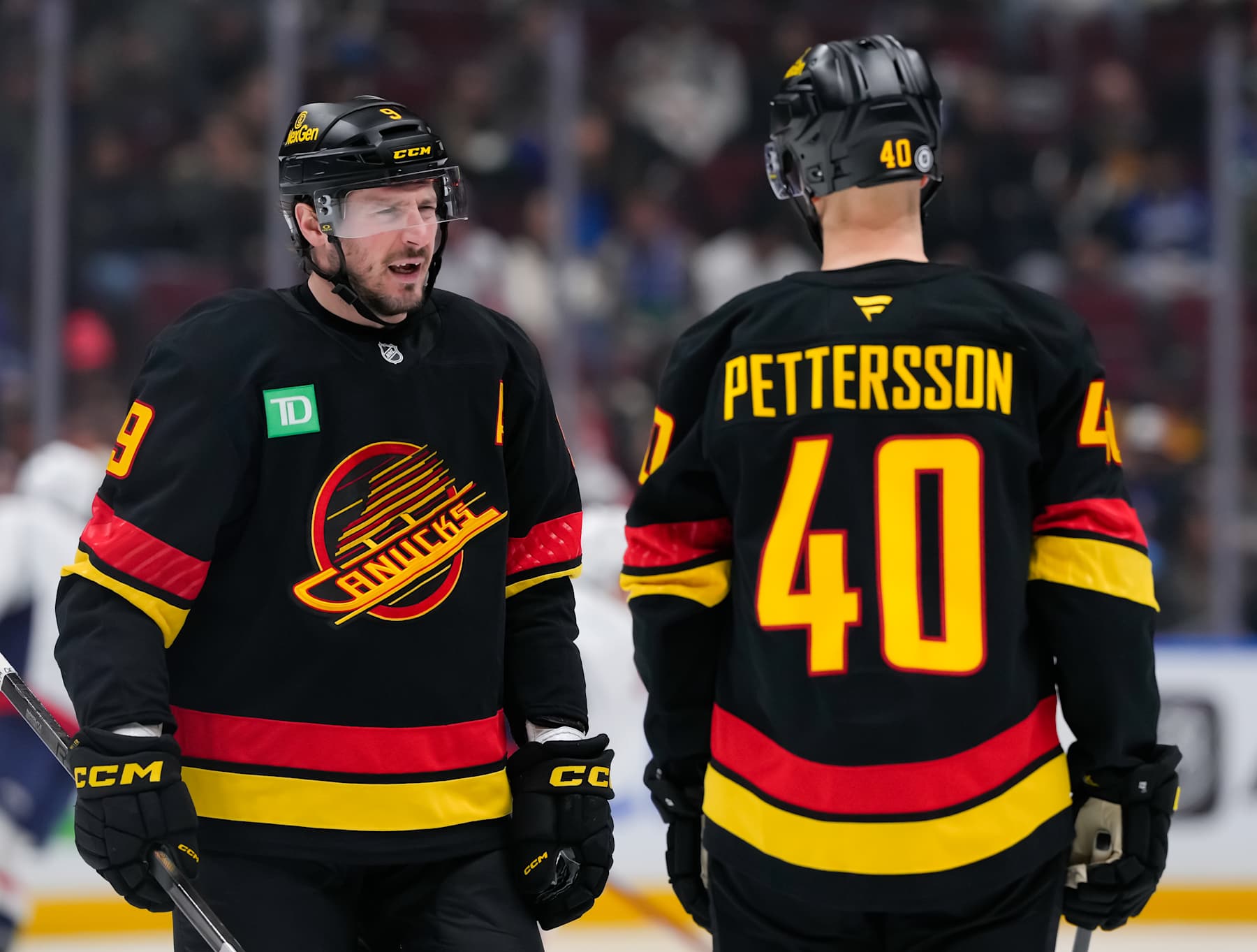 VANCOUVER, CANADA - JANUARY 25: J.T. Miller #9 of the Vancouver Canucks skates past Elias Pettersson #40 before the second period of their NHL game against the Washington Capitals at Rogers Arena on January 25, 2025 in Vancouver, British Columbia, Canada. (Photo by Derek Cain/Getty Images)